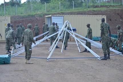 Soldiers from Uganda People’s Defence Force set up the frame of a UN-standard level-2 mobile treatment facility at the Uganda Rapid Deployment Capabilities Center in Jinja, Uganda, May 13, 2019, as a part of vendor training under the African Peacekeeping Rapid Response Partnership program.