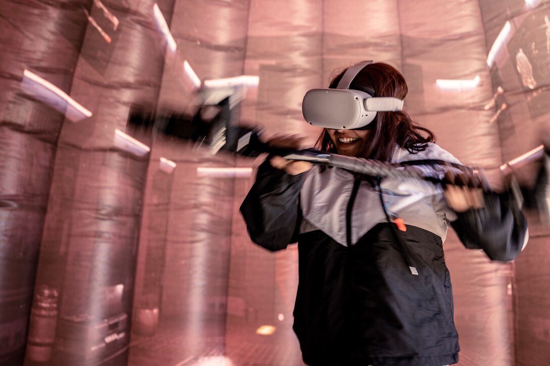 An attendee of Aviation Nation participates in "Battle Position", a Marine Corps virtual reality pugil stick game, at Nellis Air Force Base, North Las Vegas, Nev., Nov. 5, 2022. Recruiters with Recruiting Station Salt Lake City attended the Aviation Nation Air Show on November 5th and 6th where they set up “Battle Positions,” a flight simulator, and a pull-up challenge. (U.S. Marine Corps photo by Cpl. Lydia Gordon)