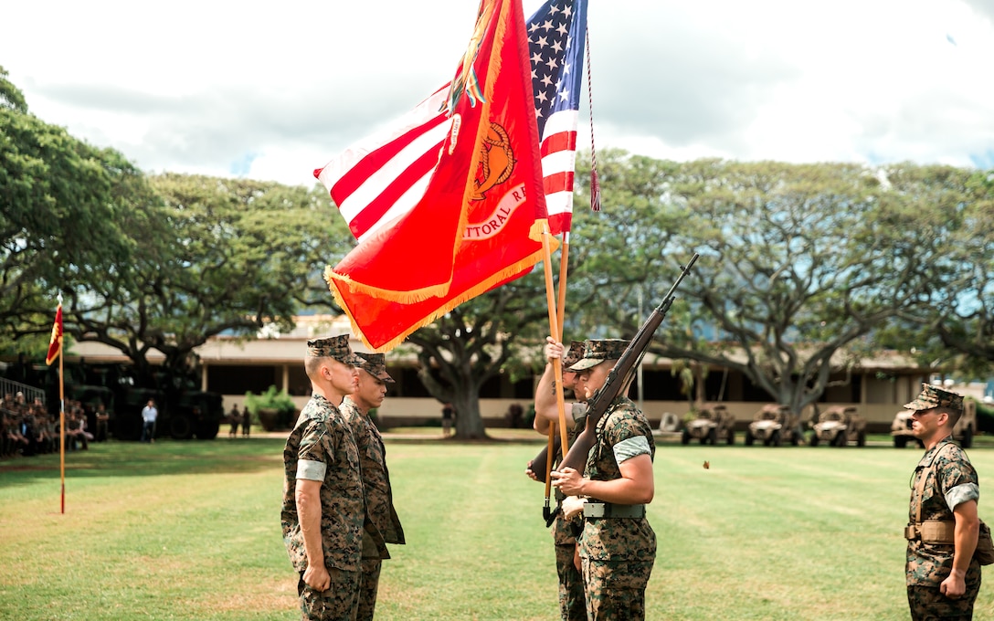 U.S. Marine Corps Col. Timothy S. Brady Jr and Sgt. Maj. Rodney E. Nevinger, 3d Marine Littoral Regiment commanding officer and sergeant major, unveil the 3d MLR unit colors during the redesignation ceremony of 3d Marines to 3d MLR aboard Marine Corps Base Hawaii, March 3, 2022. The 3d MLR will serve as a key enabler for joint, allied, and partnered forces, will integrate with naval forces, and will enable multi-domain maneuver and fires within contested spaces.  The transition of 3d Marines to 3d MLR is in accordance with Force Design 2030 and one of the first major steps to facilitating a shift as the Marine Corps divests in legacy capabilities and builds a force that is optimized for operations envisioned within the Commandant’s Planning Guidance. (U.S. Marine Corps photo by Cpl. Patrick King)