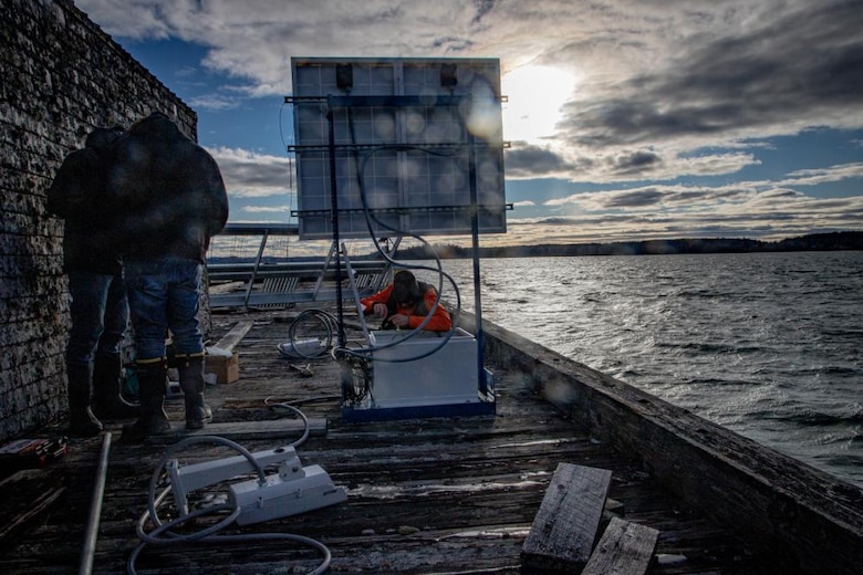 Three CRREL employees retrofit Treat Island testing facilities.