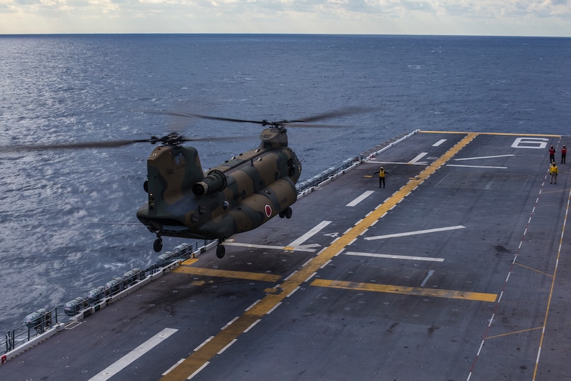 Japanese chopper lands on deck of American ship.