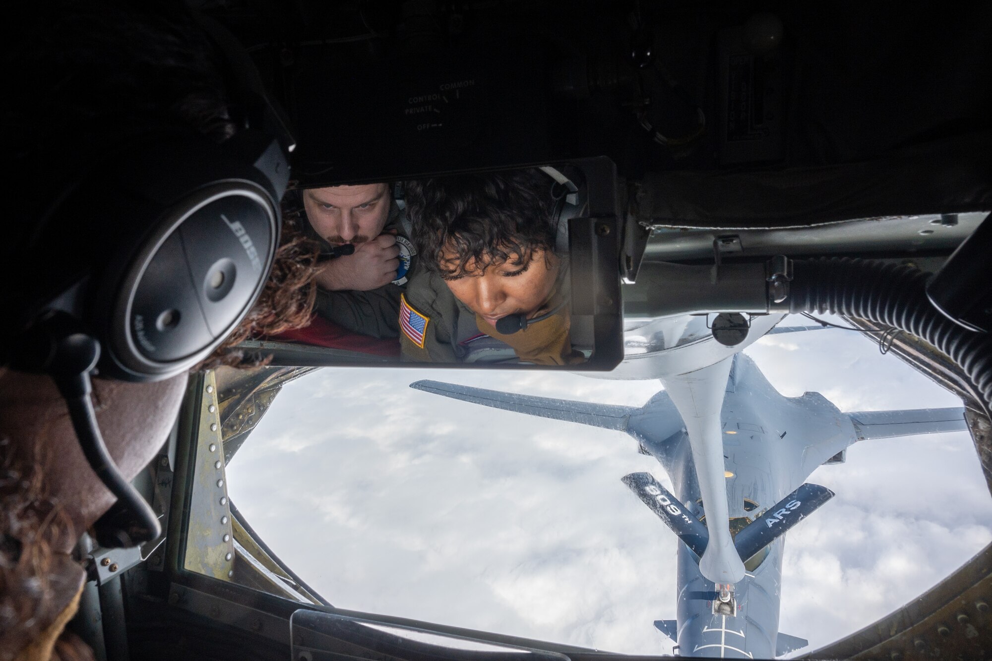 Airmen refuel an aircraft mid-flight