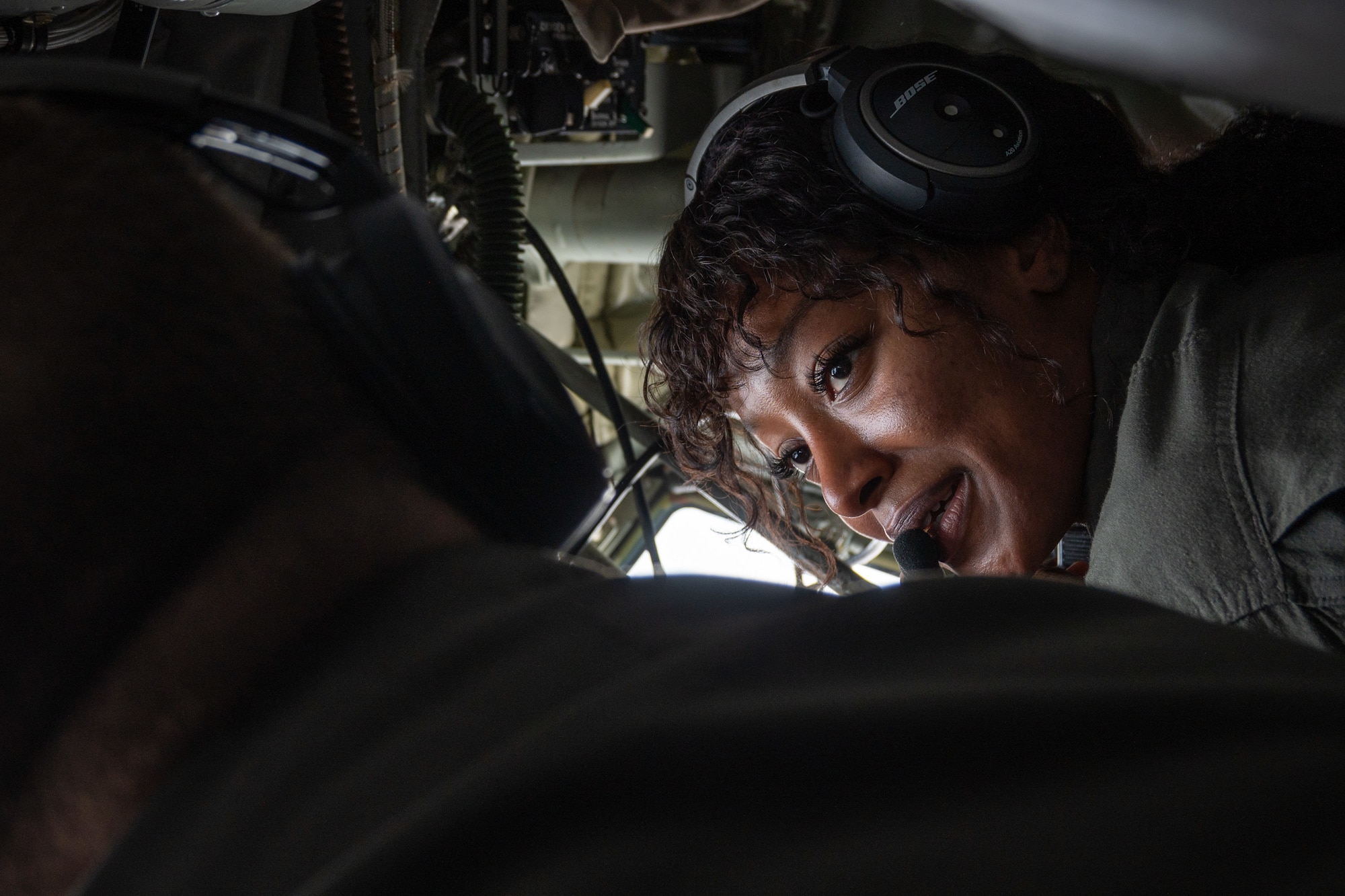 Airmen speak to each other inside of a boom pod