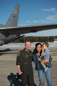 Chief Master Sgt. Tony Parris, 77th Air Refueling Squadron boom operator, and his family pose after his fini flight at Seymour Johnson Air Force Base, North Carolina, Jan. 5, 2023. A fini flight is a tradition for pilots and some aircrew members who are retiring or moving to another base to fly in an airframe a final time. (U.S. Air Force Photo by Airman 1st Class Rebecca Sirimarco-Lang)