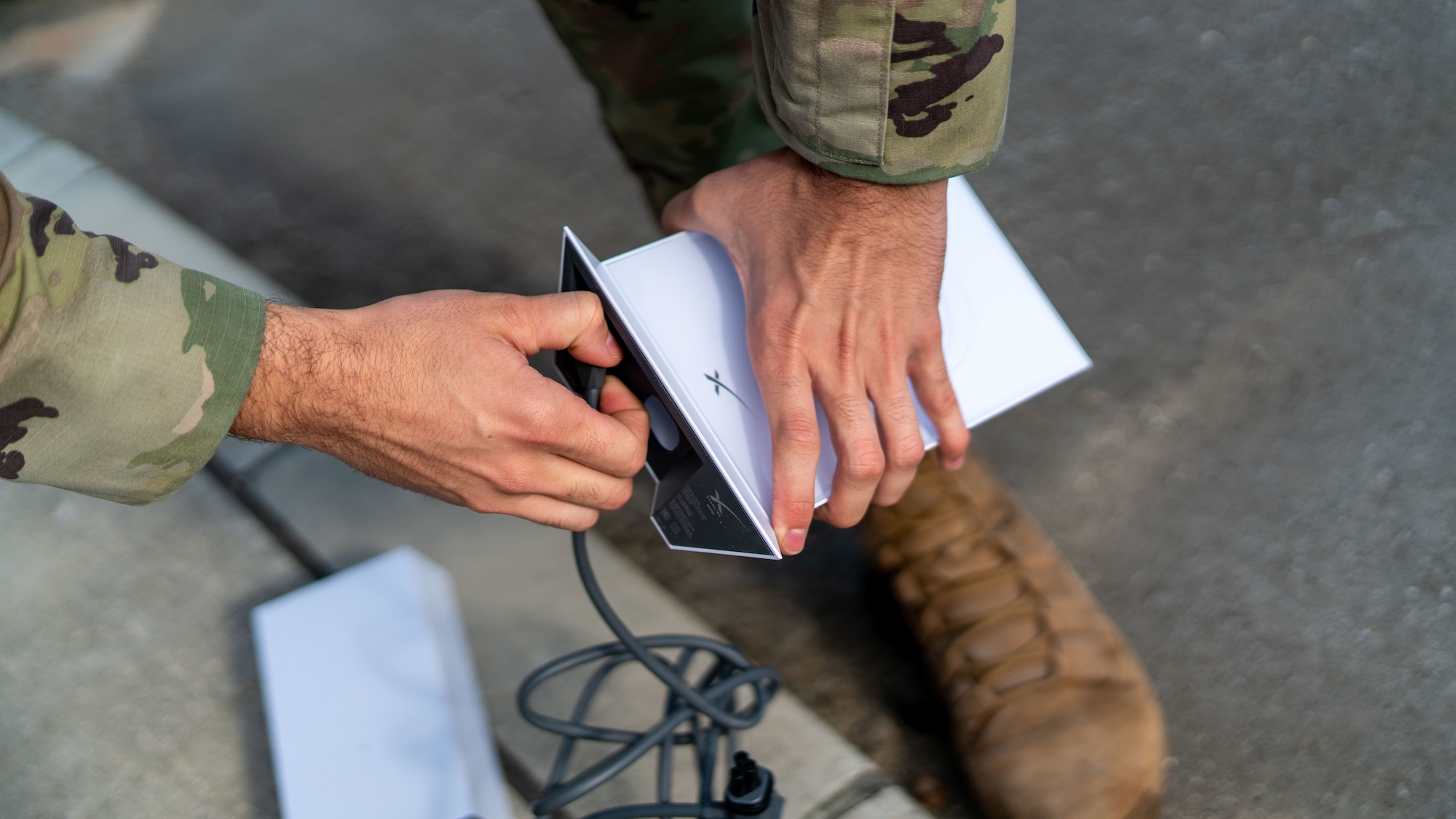 An Airman connects a modem.