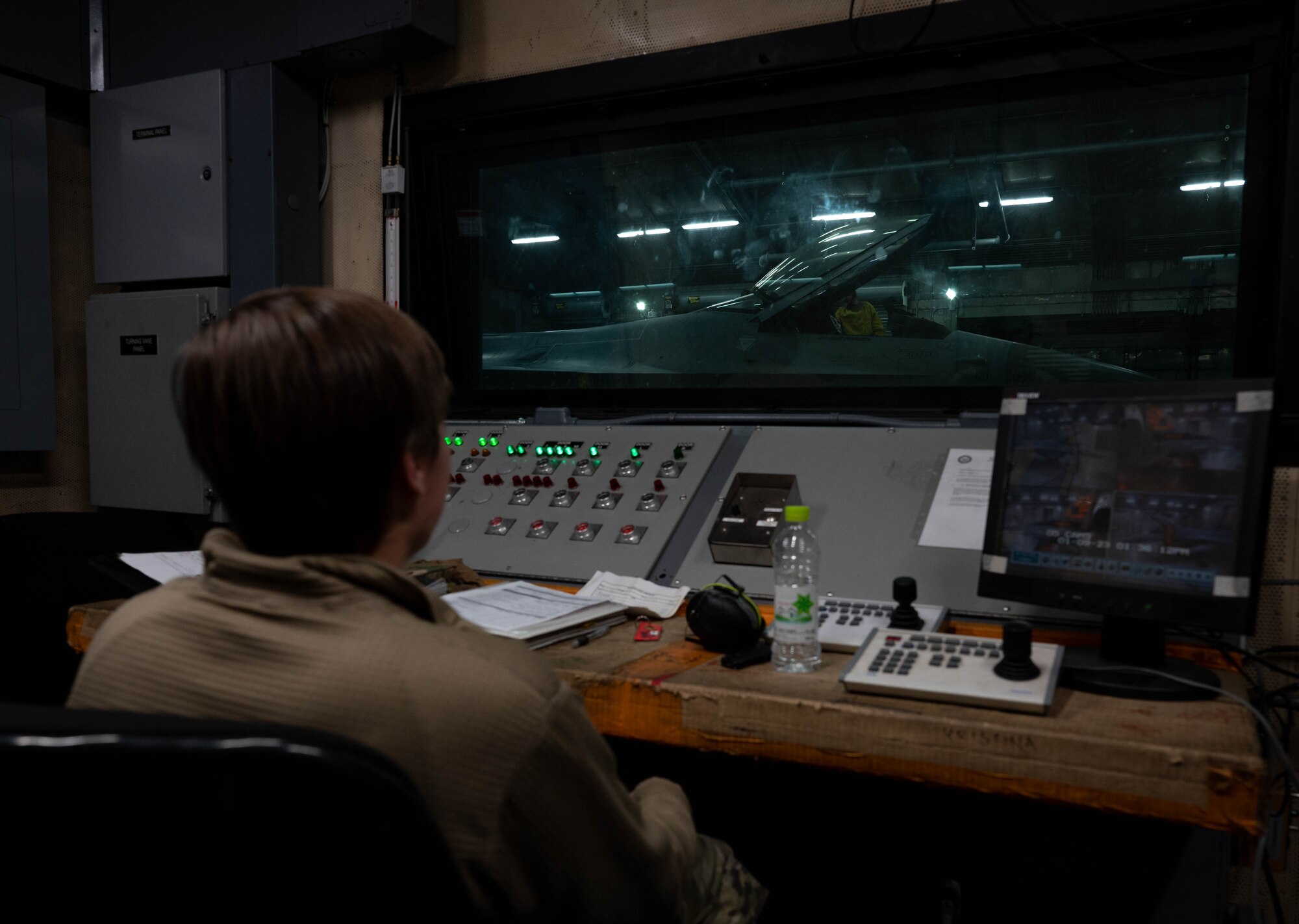 Senior Airman Mariah Owens, 8th Maintenance Squadron aerospace propulsion journeyman, monitors an F-16 Fighting Falcon before a test burn at Kunsan Air Base, Republic of Korea, Jan. 9, 2023. Additional support Airmen ensure mission safety and are always present during the testing of an engine or aircraft in the Hush House. (U.S. Air Force Photo by Senior Airman Shannon Braaten)