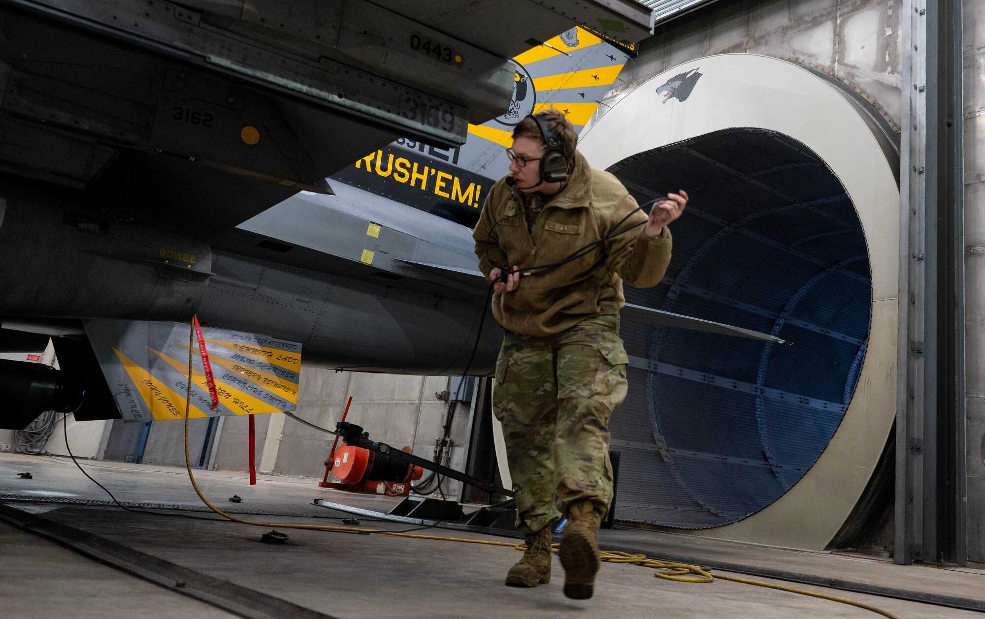 Staff Sgt. Chance Timko, 8th Maintenance Squadron aerospace propulsion journeyman, walks beside an F-16 Fighting Falcon at Kunsan Air Base, Republic of Korea, Jan. 9, 2023. Engines are tested to ensure that optimal combat readiness performance is ensured. (U.S. Air Force Photo by Senior Airman Shannon Braaten)