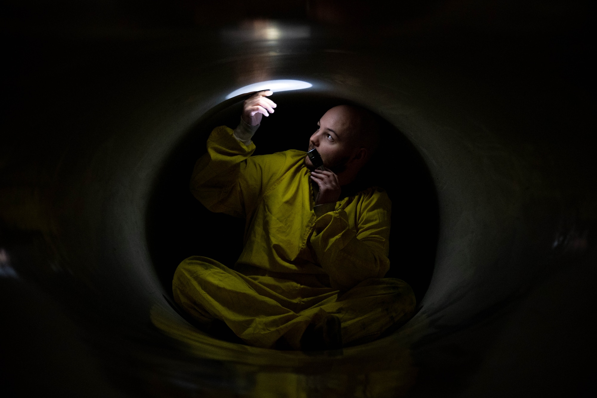 Staff Sgt. Zachary Lester, 8th Maintenance Squadron aerospace propulsion craftsman, shines a light inside an F-16 Fighting Falcon at the ‘Hush House’ on Kunsan Air Base, Republic of Korea, Jan. 9, 2023. Before firing an engine in the Hush House, Airmen verify every aspect of the aircraft is in good working order to prevent mishaps. (U.S. Air Force Photo by Senior Airman Shannon Braaten)
