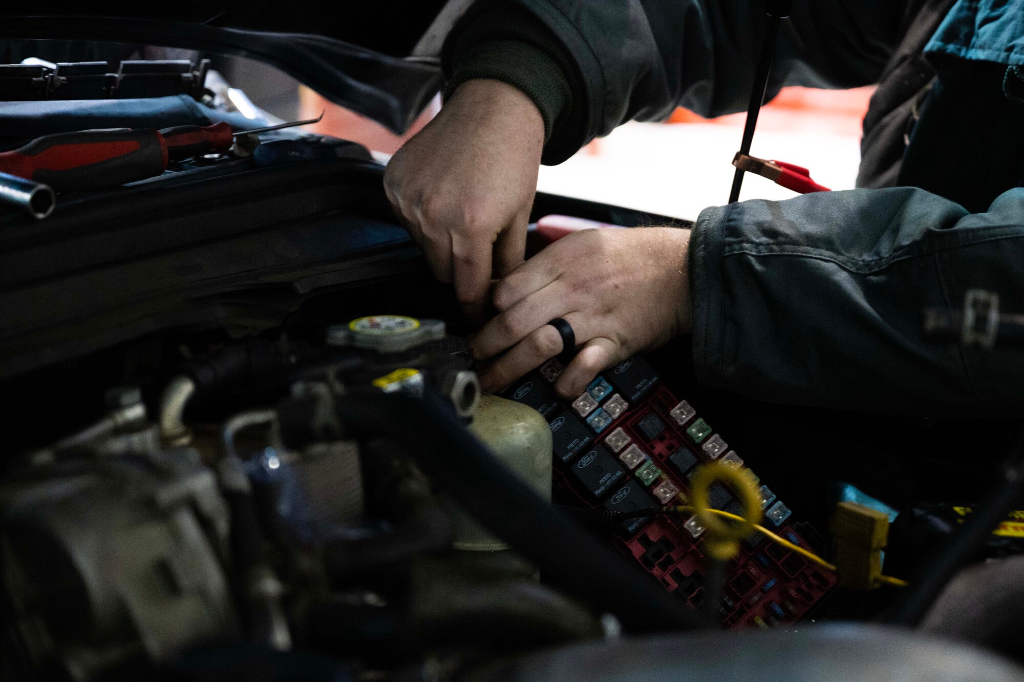 U.S. Air Force Senior Airman Cameron Sneed, 100th Logistics Readiness Squadron vehicle maintenance journeyman, troubleshoots an engine startup issue on a government vehicle at Royal Air Force Mildenhall, England, Jan. 9, 2023. Maintaining the vehicle fleet by replacing broken parts ensures operator safety and execution of the mission. (U.S. Air Force photo by Airman 1st Class Viviam Chiu)