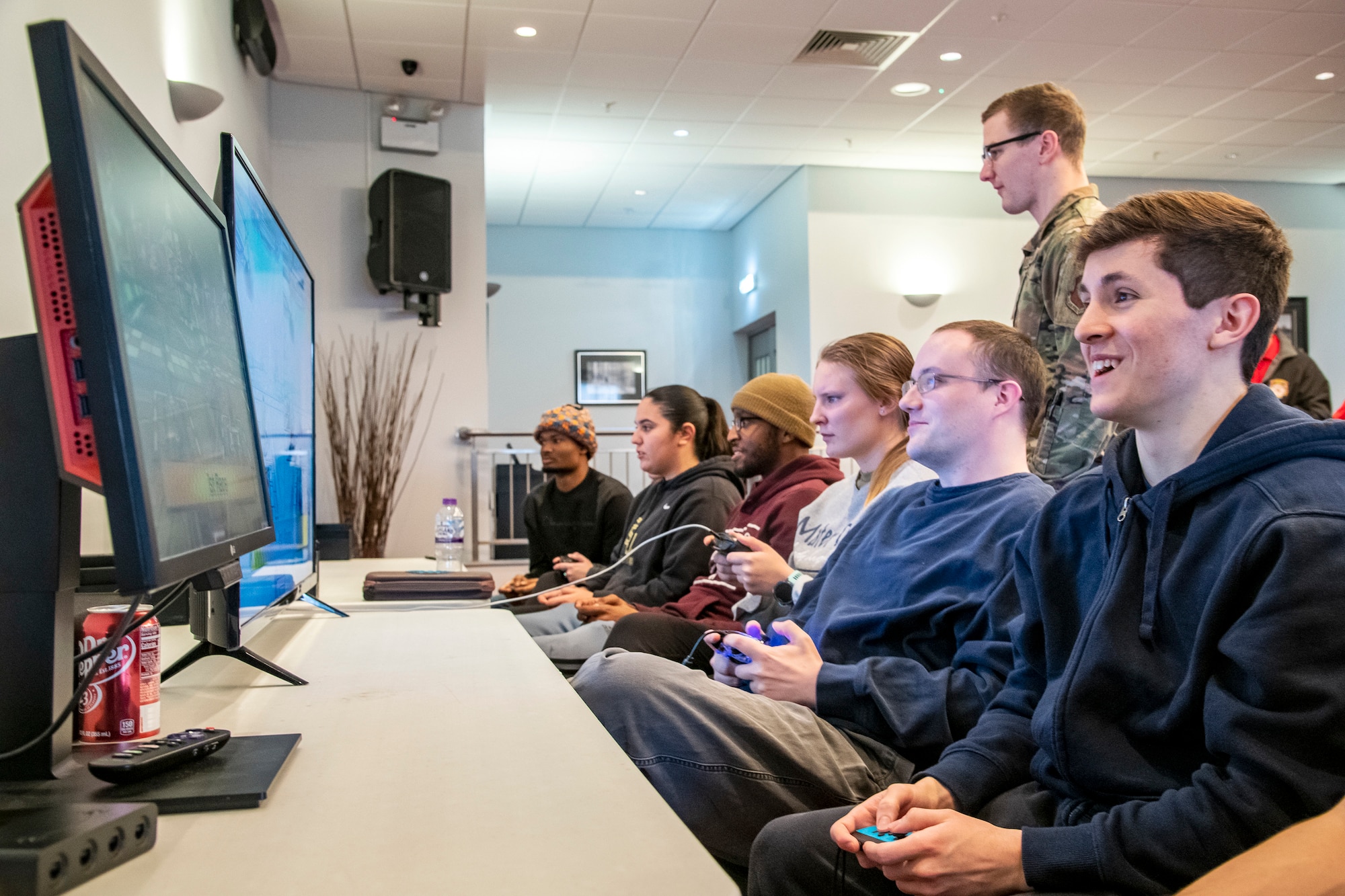 Airmen from the 501st Combat Support Wing play video games during the Crown Olympics at RAF Croughton, England, Jan. 6, 2022. Airmen from RAF Croughton, RAF Welford and RAF Fairford came together to interact and compete at various games and activities to build camaraderie and togetherness. (U.S. Air Force Photo by Staff Sgt. Eugene Oliver)