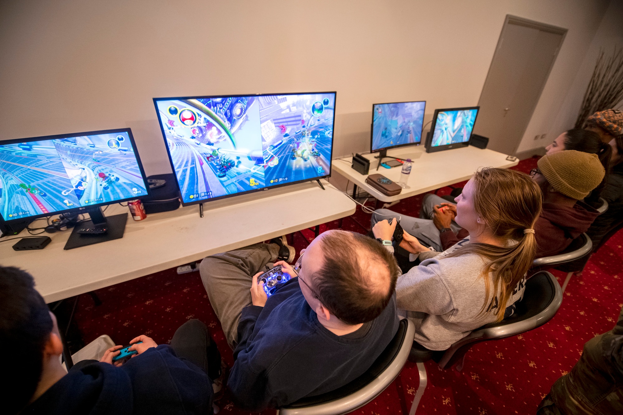 Airmen from the 501st Combat Support Wing play video games during the Crown Olympics at RAF Croughton, England, Jan. 6, 2022. Airmen from RAF Croughton, RAF Welford and RAF Fairford came together to interact and compete at various games and activities to build camaraderie and togetherness. (U.S. Air Force Photo by Staff Sgt. Eugene Oliver)
