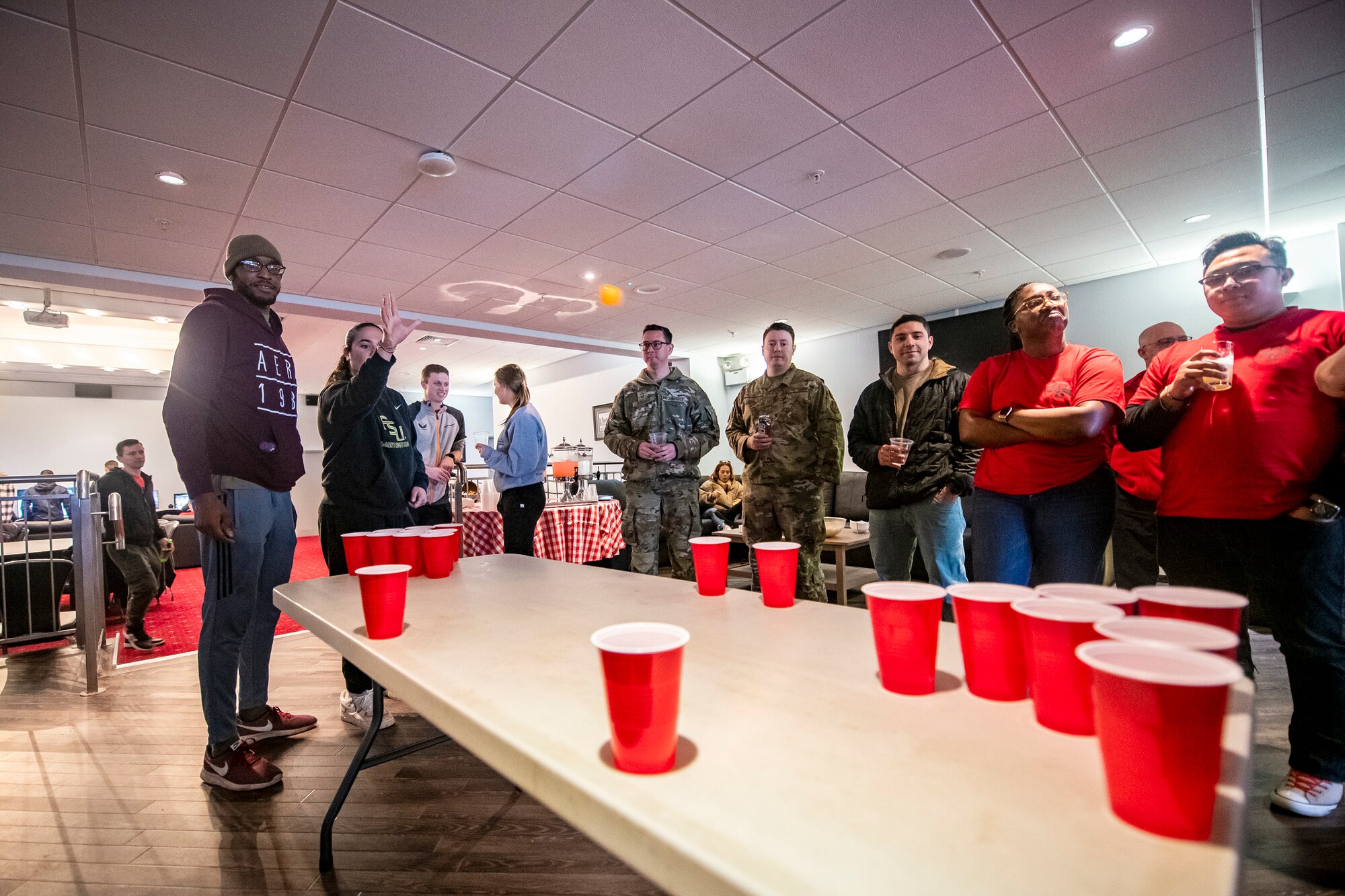 Airmen from the 501st Combat Support Wing play a game of pong during the Crown Olympics at RAF Croughton, England, Jan. 6, 2022. Airmen from RAF Croughton, RAF Welford and RAF Fairford came together to interact and compete at various games and activities to build camaraderie and togetherness. (U.S. Air Force Photo by Staff Sgt. Eugene Oliver)