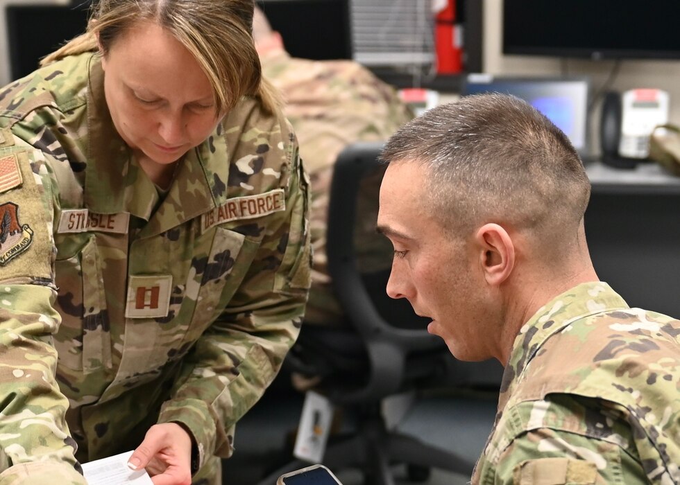 U.S. Air National Guard Capt. Jessica Strassle, 174th Medical Group, helps Senior Master Sgt. Bryan Thuman, 174th Civil Engineer Squadron, with out-processing paperwork at Hancock Air National Guard base on Dec. 30. Thuman is a part of the snow removal team responding to the snowstorm that happened in Buffalo, New York over the holiday weekend. The National Guard deployed more than 650 troops to assist city and county residents with search and rescue, emergency transportation, snow removal, health and welfare checks, decedent recovery, logistics and traffic control. (U.S. Air National Guard photo by Master Sgt. Barbara Olney)