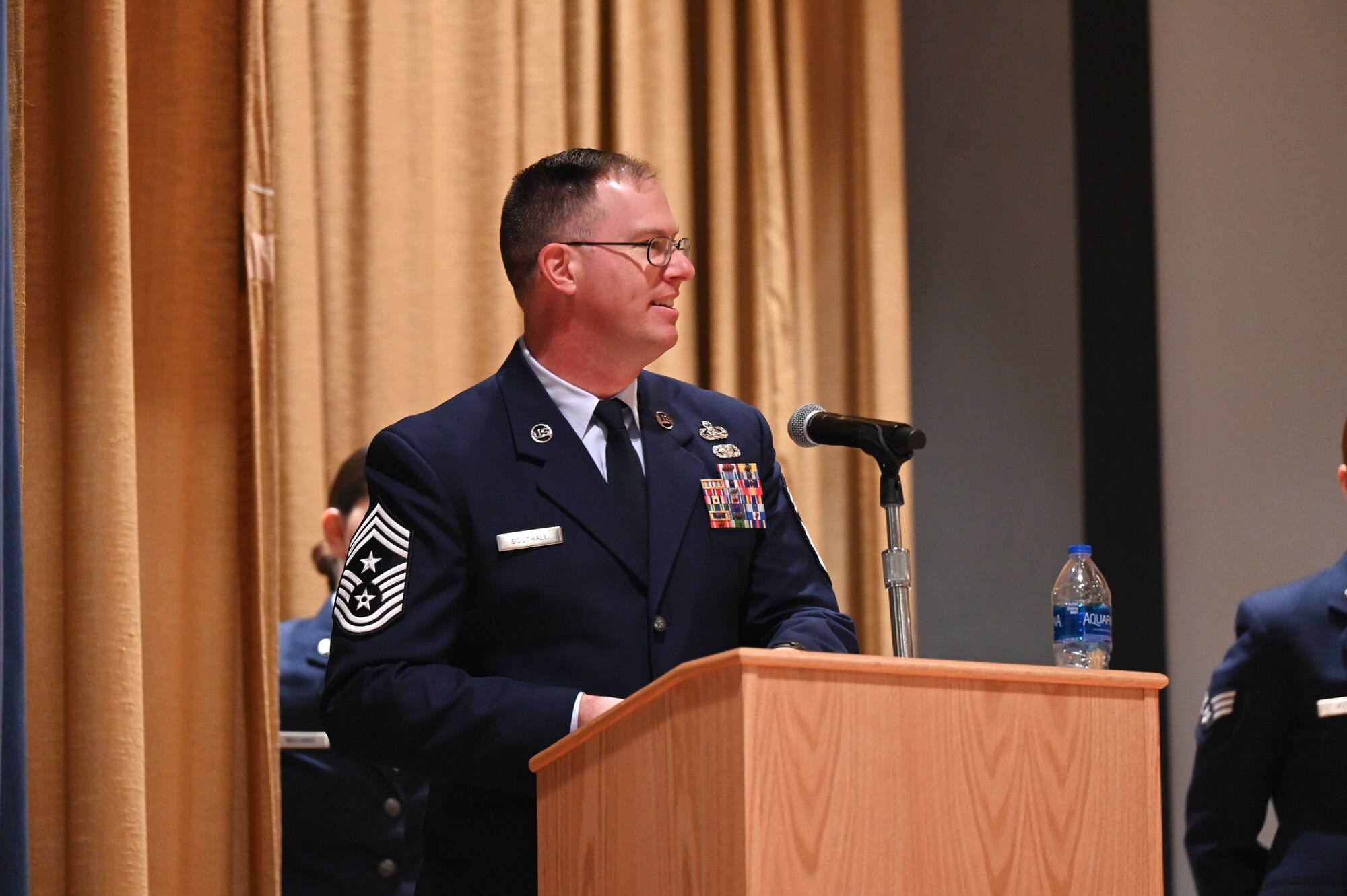 U.S. Air Force Chief Master Sgt. David Southall II, 350th Spectrum Warfare Wing command chief, gives the commencement speech for the graduating Community College of the Air Force graduation ceremony at Eglin Air Force Base, Nov. 18, 2022. 214 Airmen across Eglin earned their Associate of Applied Science degrees. (U.S. Air Force photo by 1st Lt. Benjamin Aronson)