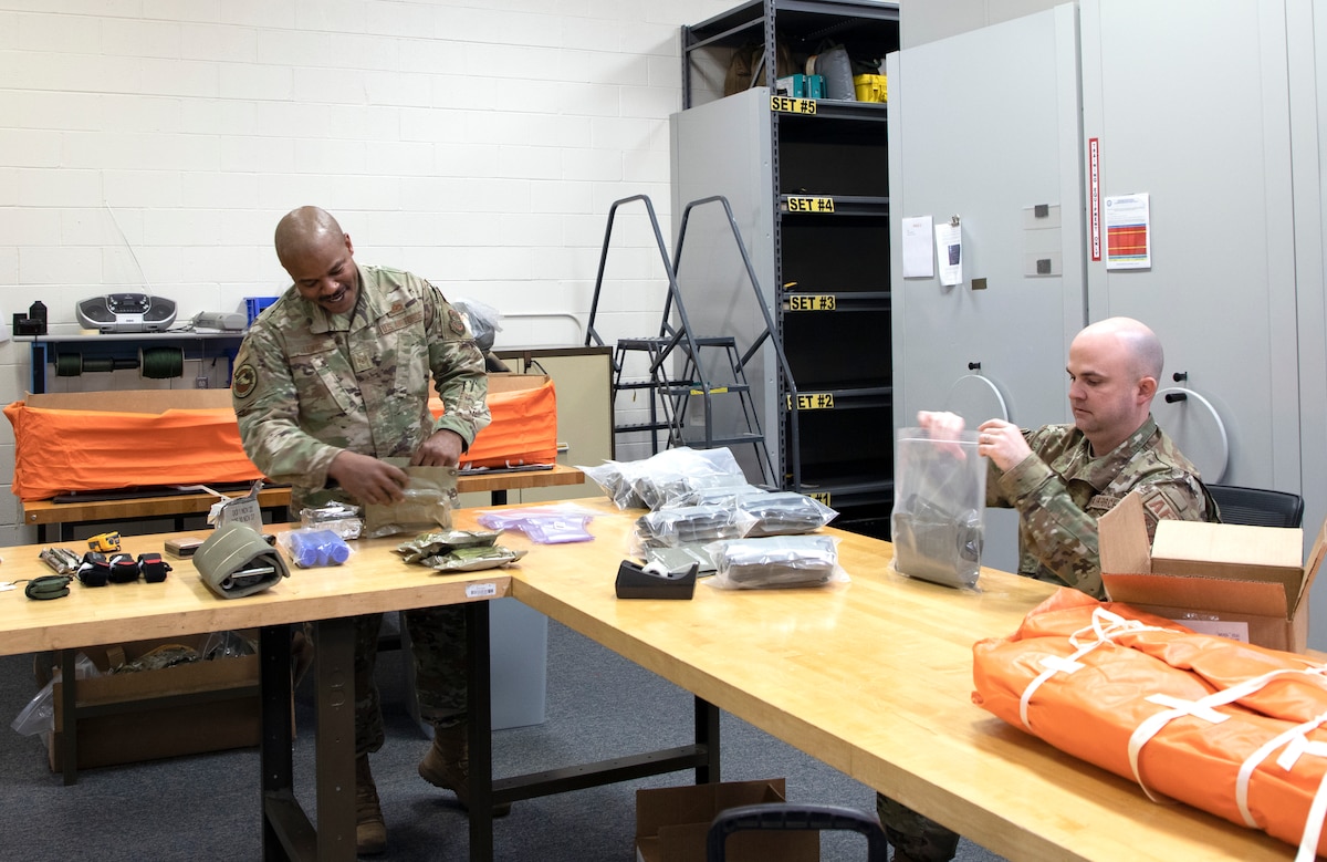 Staff Sgt. Dewon Lewis and Staff Sgt. Martin McCormick, air crew flight equipment specialists with the 191st Operations Support Squadron, conduct an inventory check on a survival kit at Selfridge Air National Guard Base, Michigan. Survival kits are reviewed and checked on an annual basis. (U.S. Air National Guard photo by Airman 1st Class Elise Wahlstrom)