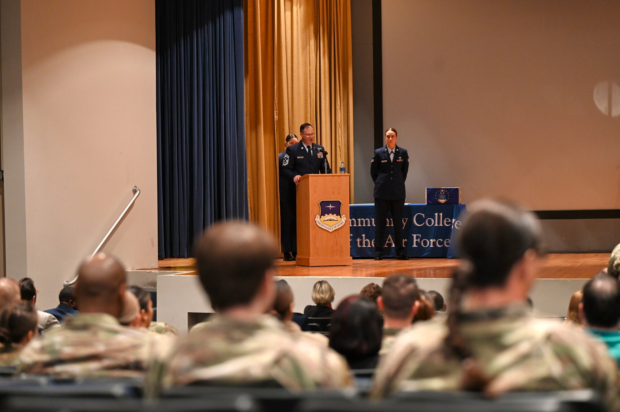 Airmen gather at the Enlisted Hall for the Community College of the Air Force graduation ceremony at Eglin Air Force Base, Nov. 18, 2022. U.S. Air Force Chief Master Sgt. David Southall II, 350th Spectrum Warfare Wing command chief, was selected to give the commencement speech for the ceremony. (U.S. Air Force photo by 1st Lt. Benjamin Aronson)