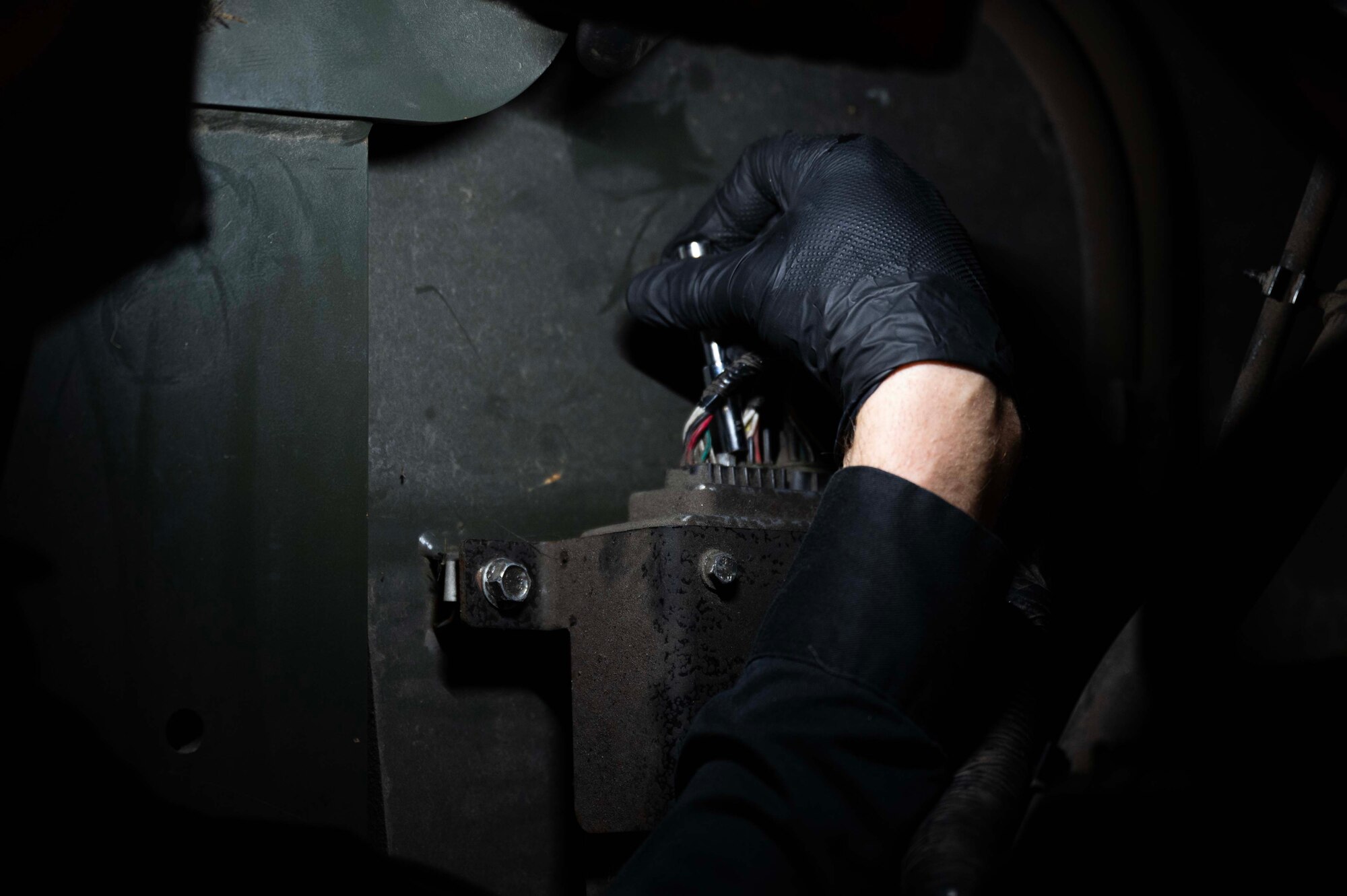 U.S. Air Force Staff Sgt. Daniel Payne, 100th Logistics Readiness Squadron NCO in charge of material handling equipment, repairs an electrical malfunction in a government vehicle at Royal Air Force Mildenhall, England, Jan. 9, 2023. Payne’s job involves scheduling maintenance for government vehicles that aid air transportation. (U.S. Air Force photo by Airman 1st Class Viviam Chiu)
