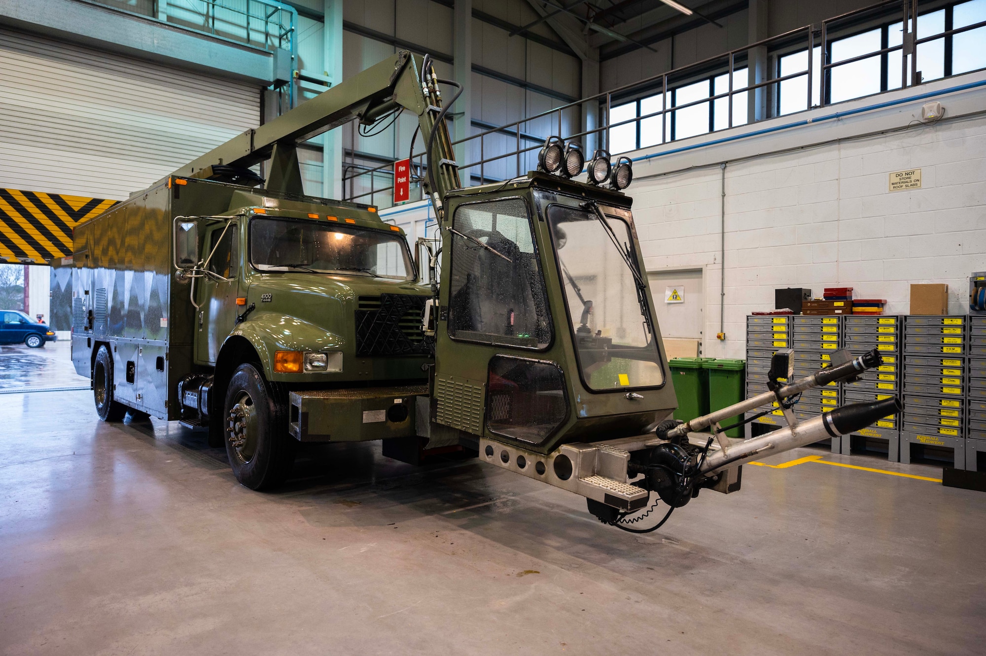 A U.S. government aircraft deicing truck prepares for routine maintenance at Royal Air Force Mildenhall, England, Jan. 9, 2023. Vehicle mechanics inspect, troubleshoot, order and replace parts to ensure vehicles run properly. (U.S. Air Force photo by Airman 1st Class Viviam Chiu)