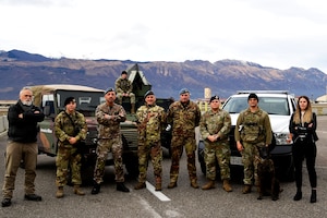 Members from the 31st Fighter Wing Anti-Terrorism office, 31st Security Forces military working dog handler and dog, 31st Security Forces Squadron and Italian Air Force Security personnel pose for a photo at Aviano Air Base, Italy, Jan. 12, 2023. Aviano Anti-Terrorism is a joint effort across multiple squadrons, units and our NATO Allies. (U.S. Air Force photo by Senior Airman Noah Sudolcan)