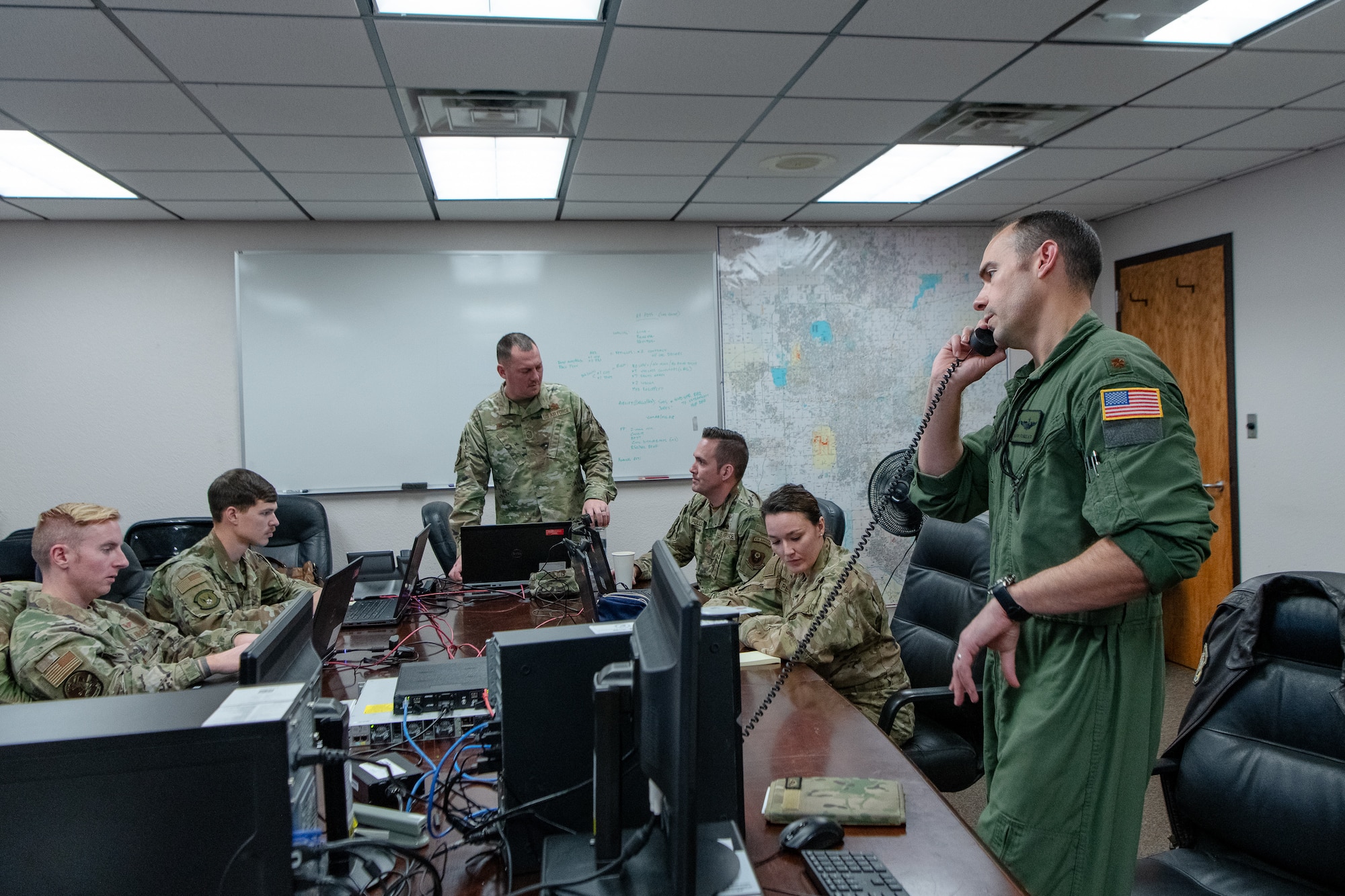 airmen work around a table to conduct operations