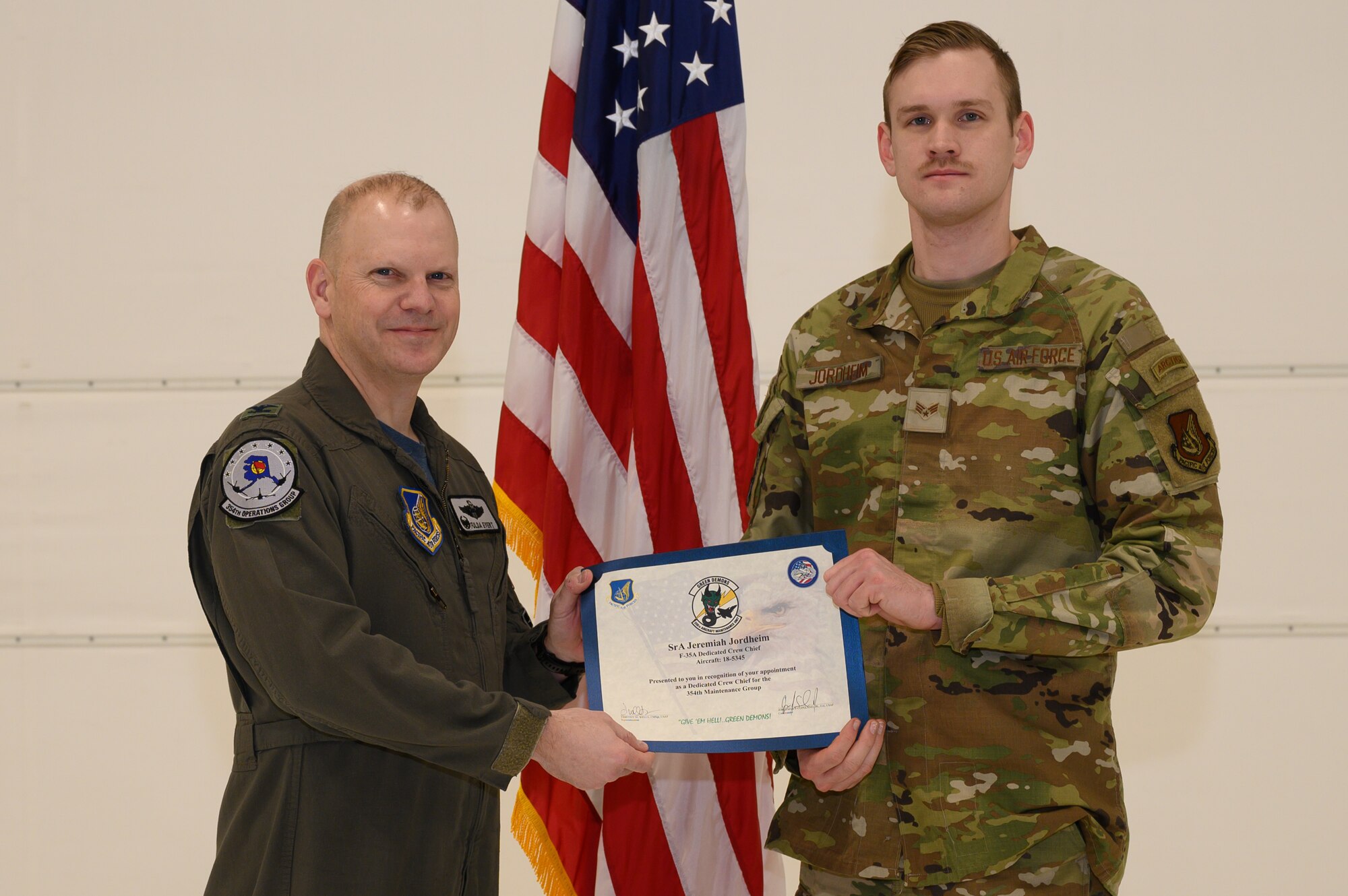U.S. Air Force Col. Gage Evert, 354th Operations Group commander, poses for a photo with Senior Airman Jeremiah Jordheim, a 356th Aircraft Maintenance Unit crew chief, during a ceremony on Eielson Air Force Base, Alaska, Jan. 6, 2023.