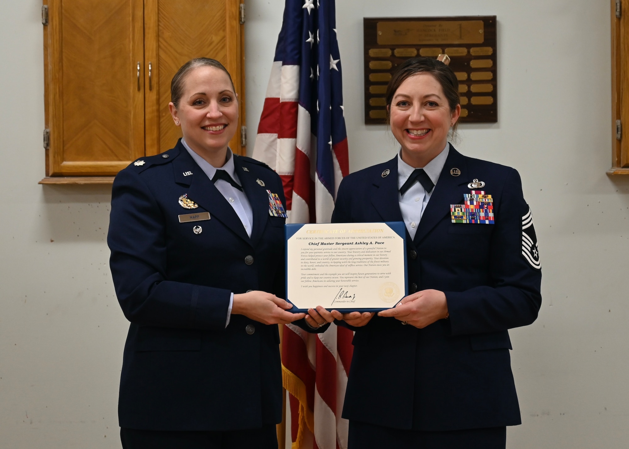 New York Air National Guard Chief Master Sgt. Ashley A. Pace (right) receives a Certificate of Appreciation from Lt. Col. Jennifer Mapp,  during a retirement ceremony held at Hancock Field Air National Guard Base, Syracuse, New York. (U.S. Air National Guard photo by Staff Sgt. Duane Morgan)