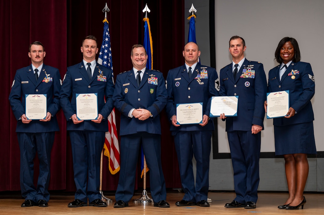 A group of Airmen pose for a photo.