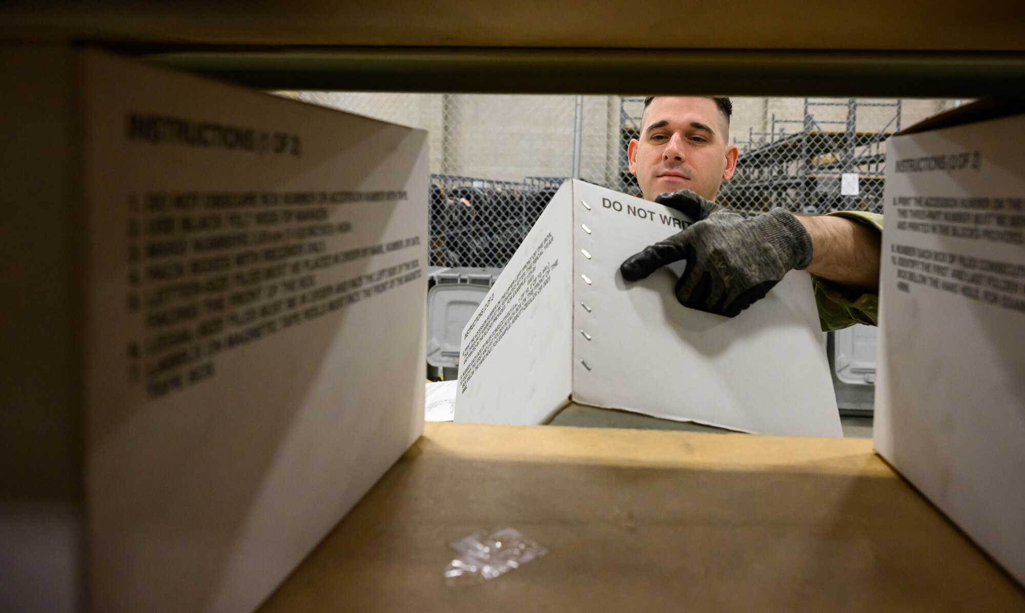 Staff Sgt. Jared Sylvester, 75th Communications and Information Directorate knowledge operations manager, processes boxed records at the Records Staging Facility at Hill Air Force Base, Utah, Dec. 22, 2022.  The Office of Management and Budget directed the Air Force to close all agency operated paper storage facilities and transfer permanent and long-retention records to Federal Records Centers operated by the National Archives and Records Administration by Dec. 31, 2022. The staging facility at Hill provided supported to more than 100 organizations. (U.S. Air Force photo by R. Nial Bradshaw)