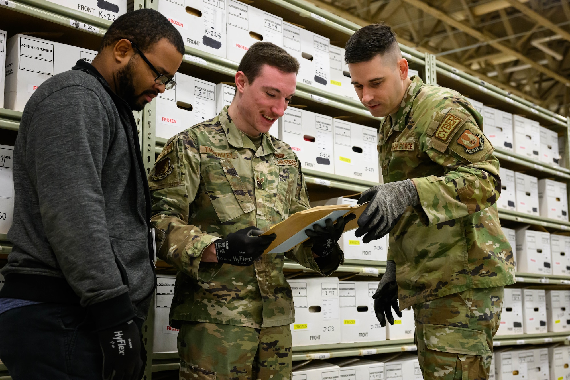 Left to right,  Bryce Terry, Senior Airman Brandon Tankersley and Staff Sgt. Jared Sylvester, 75th Communications and Information Directorate, process boxed records at the Records Staging Facility, Hill Air Force Base at Utah, Dec. 22, 2022.  The Office of Management and Budget directed the Air Force to close all agency operated paper storage facilities and transfer permanent and long-retention records to Federal Records Centers operated by the National Archives and Records Administration by Dec. 31, 2022. The staging facility at Hill provided supported to more than 100 organizations. (U.S. Air Force photo by R. Nial Bradshaw)