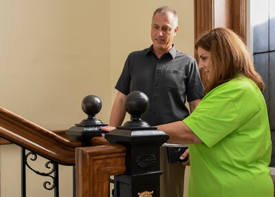 Man and woman talking on staircase.