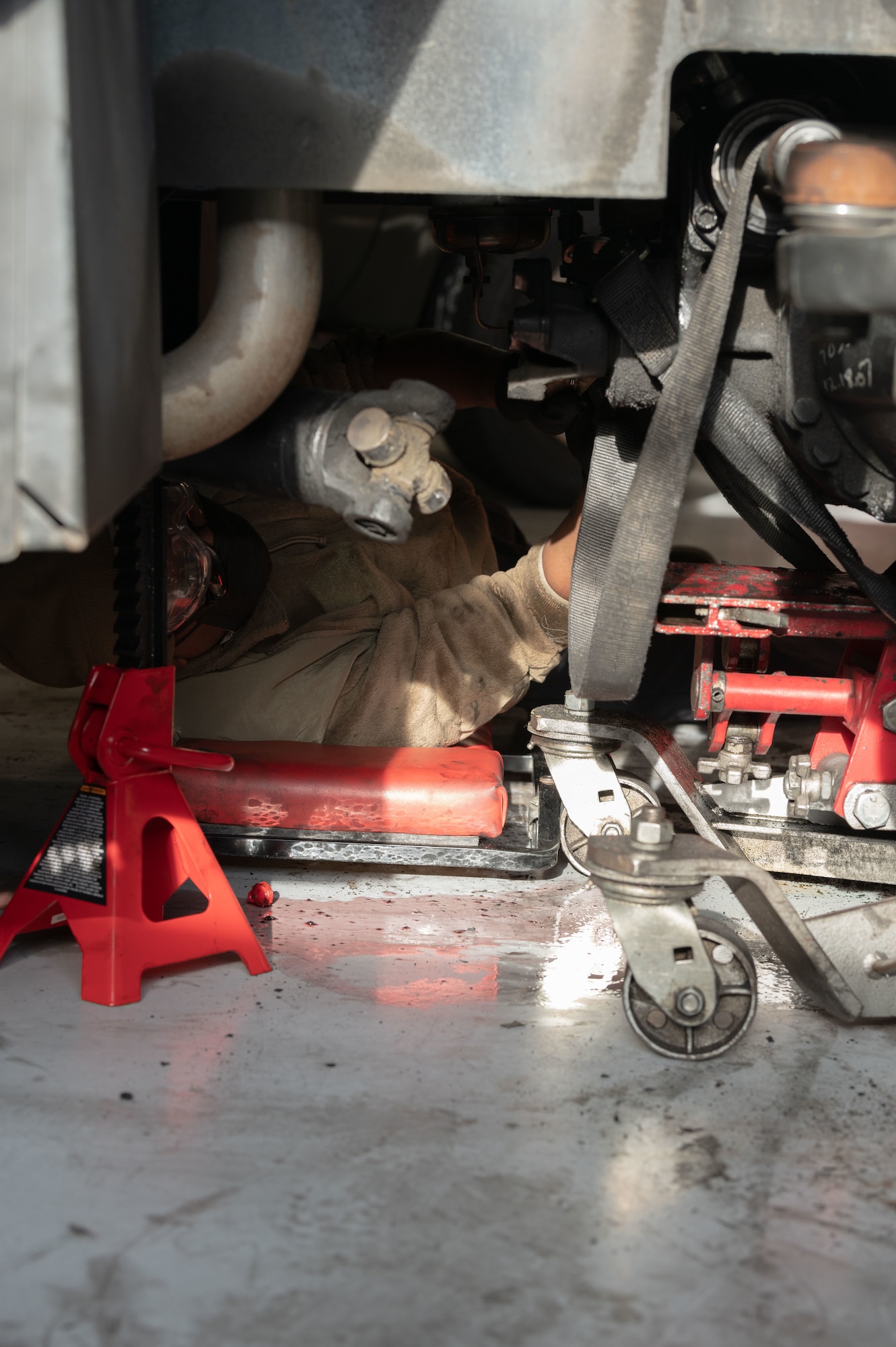 Airman 1st Class Bethwel Waitiki, 4th Logistics Readiness Squadron vehicle maintainer, works on an MB-4 towing and push back tractor at Seymour Johnson Air Force Base, North Carolina, Jan. 10, 2023. Vehicle maintenance Airmen are in charge of vehicle inspections, diagnostics and repair and keeping inventory of any spare parts for Government Owned Vehicles. (U.S. Air Force photo by Airman 1st Class Rebecca Sirimarco-Lang)
