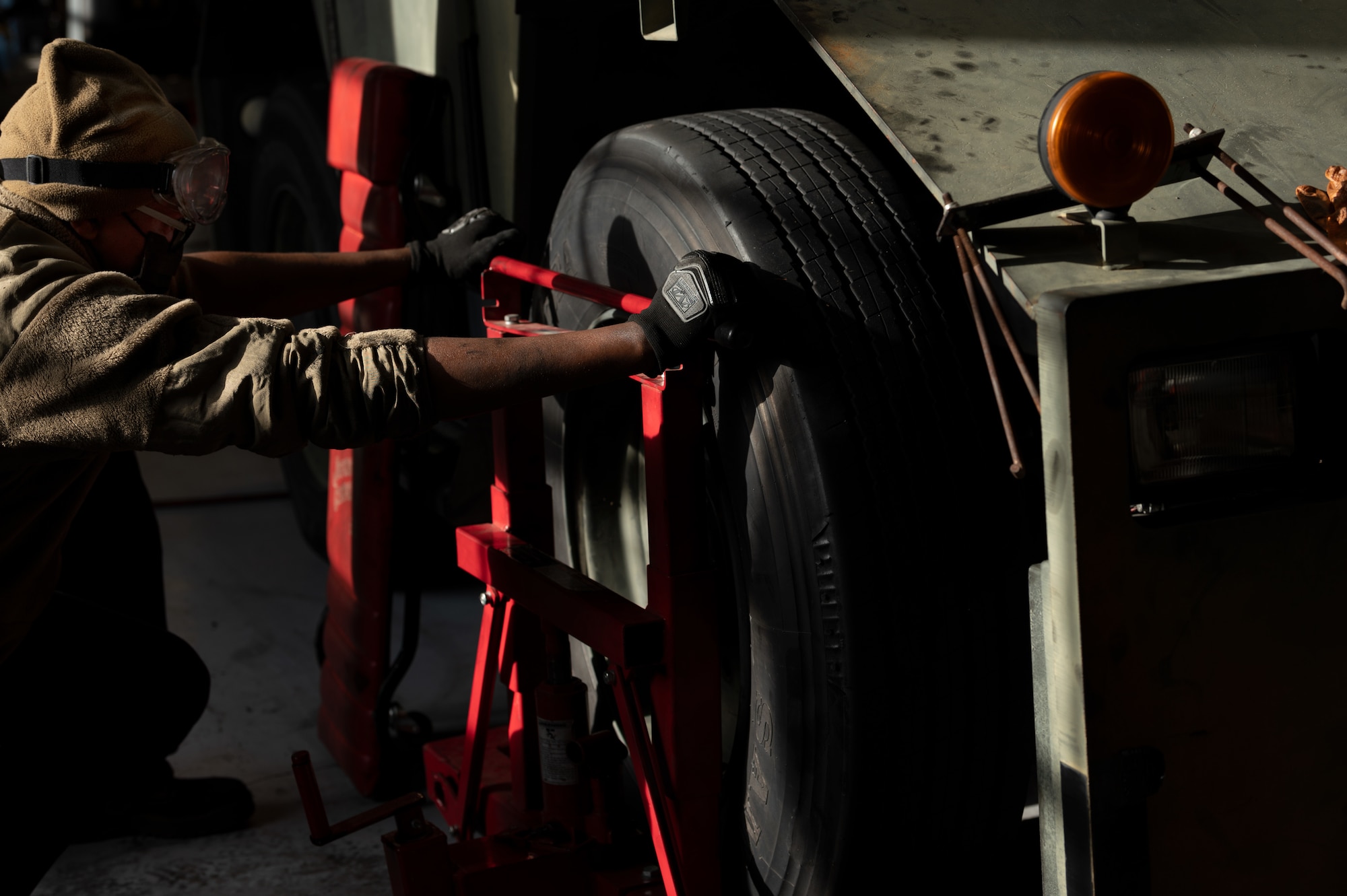 Airman 1st Class Bethwel Waitiki, 4th Logistics Readiness Squadron vehicle maintainer, places a tire on an MB-4 towing and push back tractor at Seymour Johnson Air Force Base, North Carolina, Jan. 10, 2023. The vehicle maintenance flight is responsible for all the Government Owned Vehicles on base and keeping them operating smoothly. (U.S. Air Force photo by Airman 1st Class Rebecca Sirimarco-Lang)
