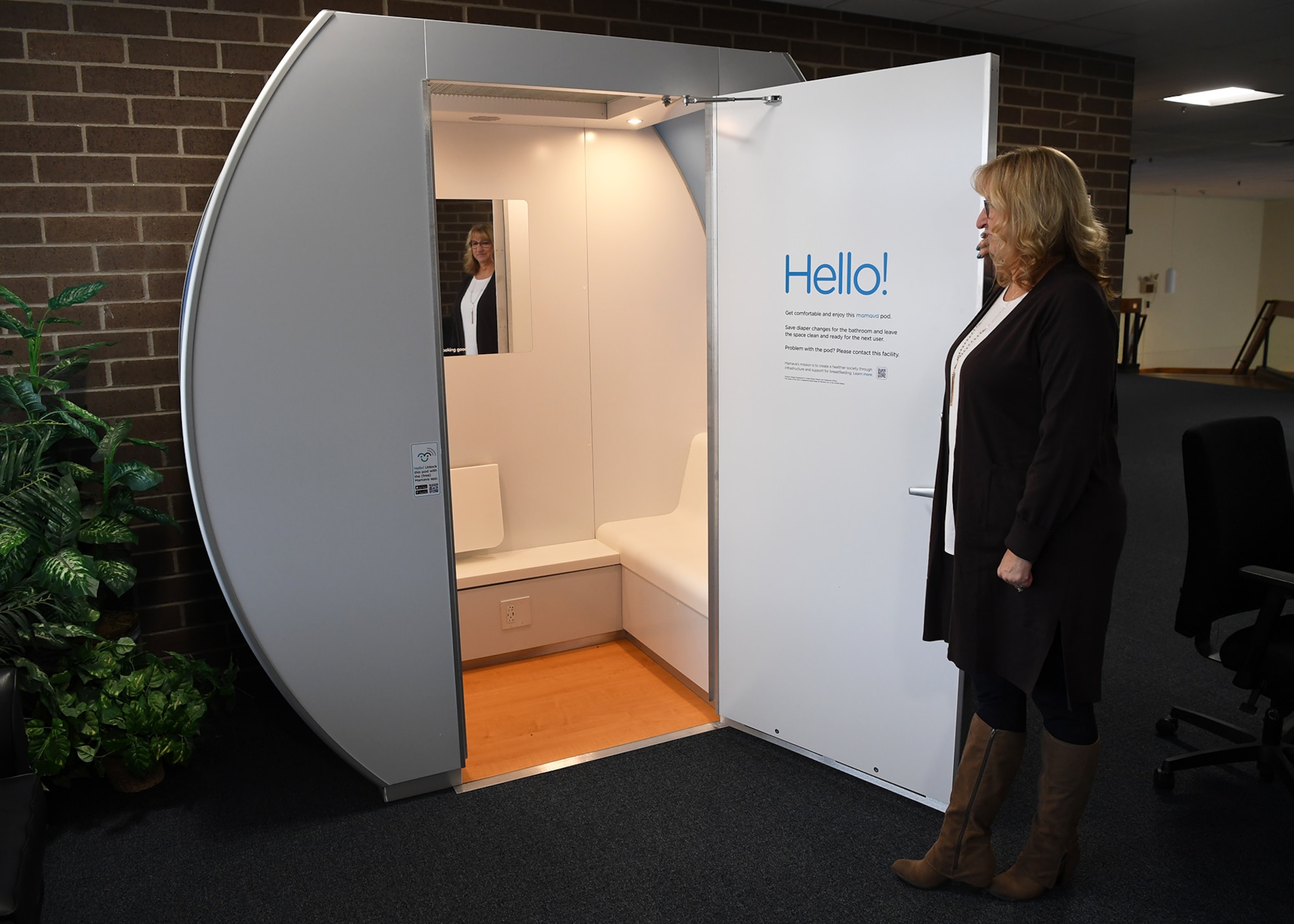 Joyce Denham, 66th Comptroller Squadron deputy comptroller, opens the new lactation pod in the Brown Building, building 1305, at Hanscom Air Force Base, Mass., Jan. 12. The pod offers a secure, private room for nursing and pumping mothers, who can view locations and occupancy of the pod through a phone application. (U.S. Air Force photo by Lauren Russell)