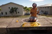 A volunteer applies a “No Dumping” sign during Operation Clean Water Ohana, Marine Corps Base Hawaii, Jan. 3, 2023. The purpose of Operation Clean Water Ohana is to protect resources and raise awareness of potential contaminants that wash down storm drains, ending up in the ocean. (U.S. Marine Corps photo by Lance Cpl. Clayton Baker)