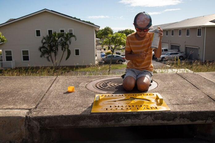 A volunteer applies a “No Dumping” sign during Operation Clean Water Ohana, Marine Corps Base Hawaii, Jan. 3, 2023. The purpose of Operation Clean Water Ohana is to protect resources and raise awareness of potential contaminants that wash down storm drains, ending up in the ocean. (U.S. Marine Corps photo by Lance Cpl. Clayton Baker)