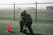 U.S. Marine Corps Cpl. Triston Gilpin, communications and navigation systems technician, Marine Aviation Logistics Squadron 24, begins the ammunition can carry portion of the bomb suit agility test as part of the Explosive Ordinance Disposal screening process, Marine Corps Base Hawaii, Jan. 10, 2023. The purpose of the event was to demonstrate EOD’s capabilities, test the capabilities of the Marines participating in the screening, and recruit new members.(U.S. Marine Corps photo by Lance Cpl. Terry Stennett III)