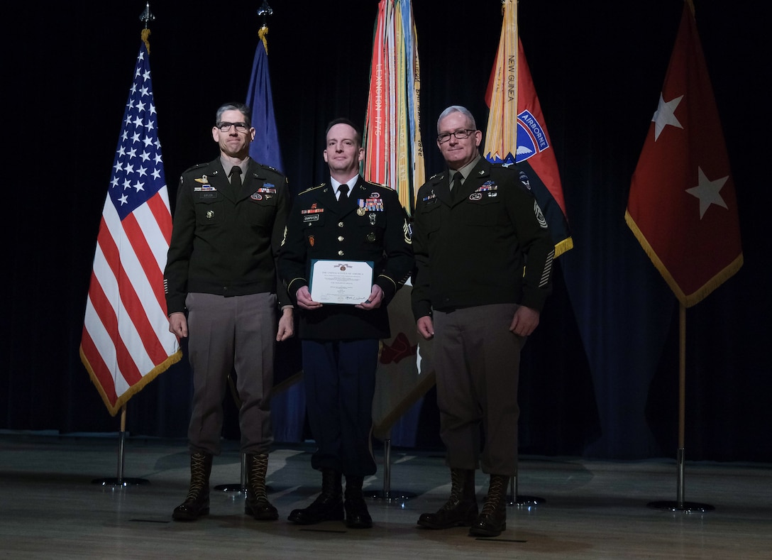 Arctic Angels stand at the end of a ceremony to present the Soldier's Medal to Army Sgt. 1st Class Andrew Chapoton, 11th Airborne Division, at Joint Base Elmendorf-Richardson, Alaska, Jan. 12.