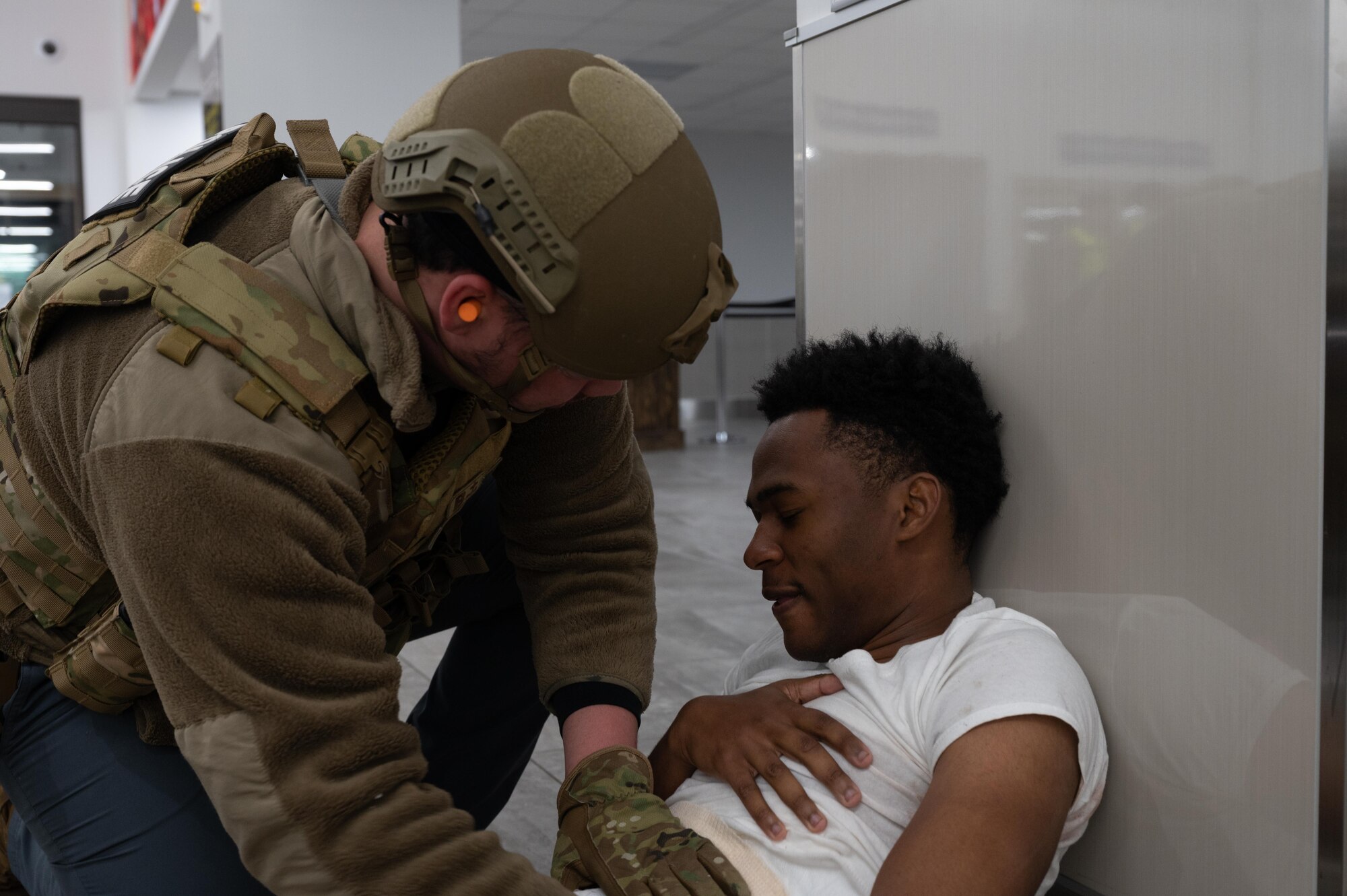 A medic assists a simulated victims injuries
