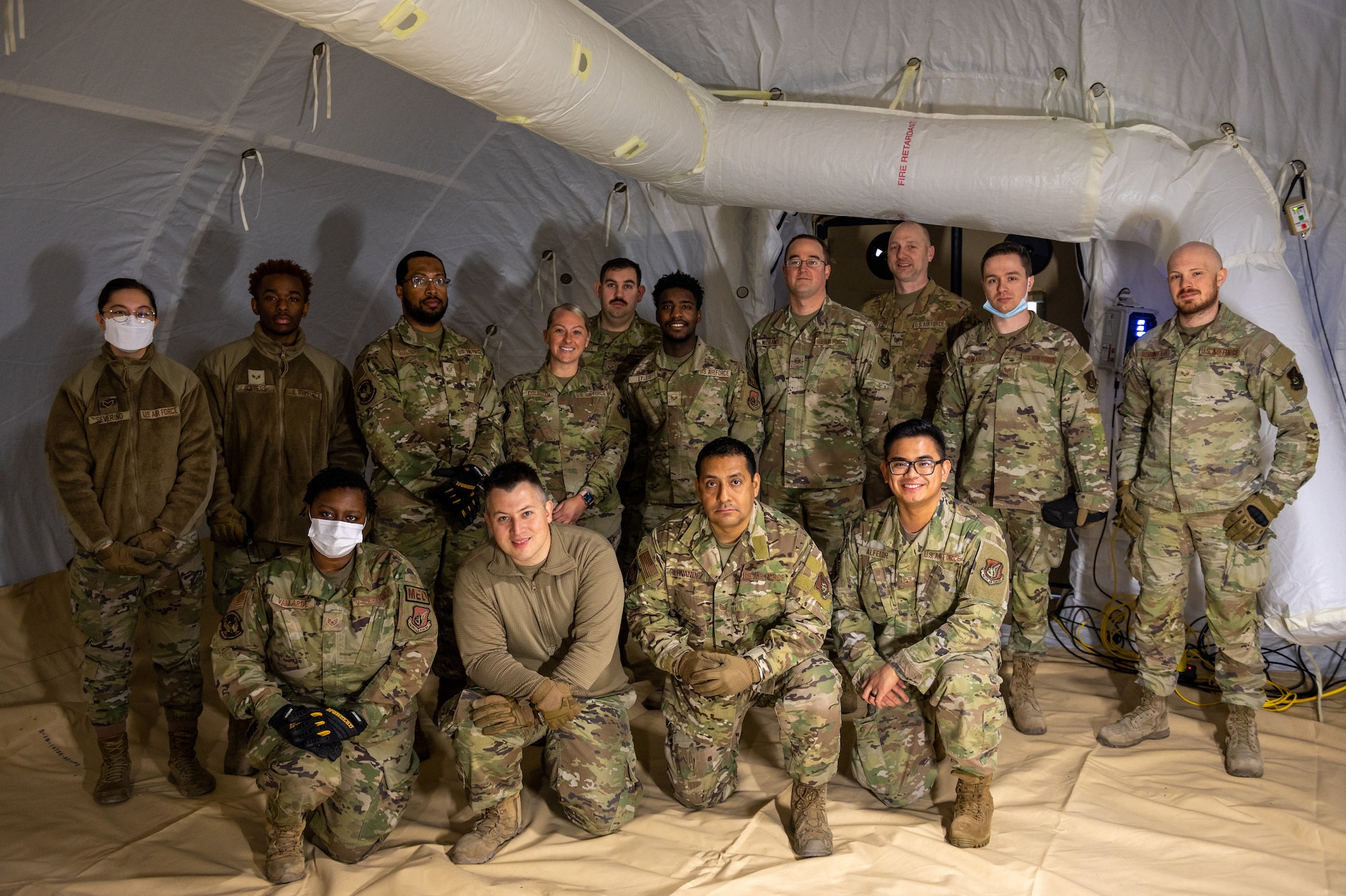 Members of the 51st Medical Group pose for a photo inside a fully pressurized Tent Kit 2 (TK2) expeditionary medical support shelter while participating in a training event at Osan Air Base, Republic of Korea, Jan. 12, 2023.