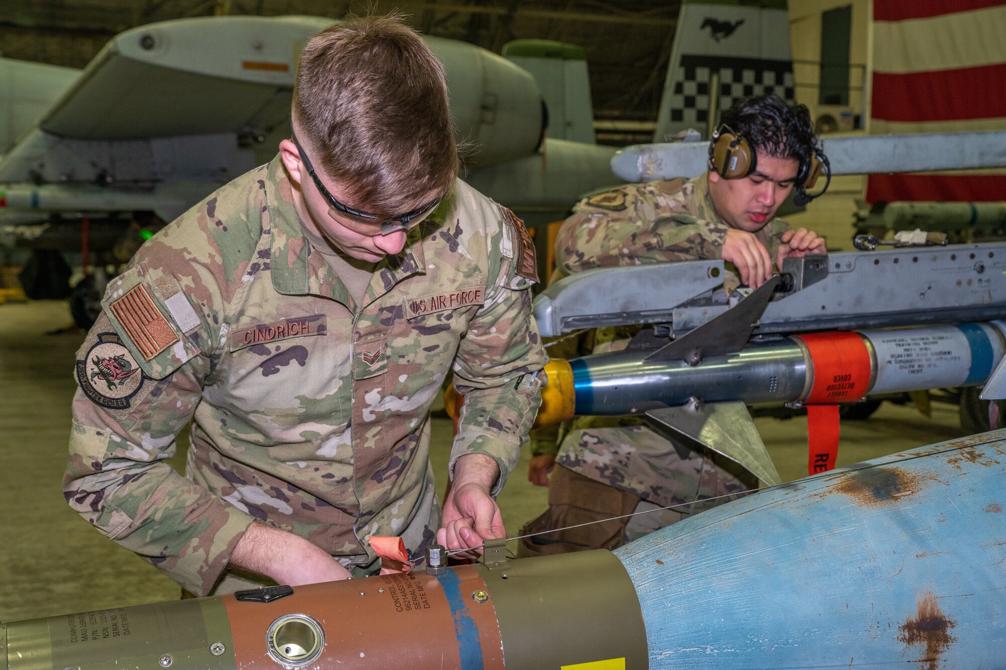 U.S. Air Force Staff Sgt. John Carlo Miranda, 36th Fighter Generation Squadron weapons load crew team leader, right, and Senior Airman Logan Cindrich, 36th FGS weapons load crew member, load munitions onto an F-16 Fighting Falcon during the fourth quarter load crew competition on Osan Air Base, Republic of Korea, Jan. 12, 2023. Load crews must prove themselves during monthly proficiency loads, quarterly evaluations and everyday mission requirements to participate in the competition. (U.S. Air Force photo by Airman 1st Class Aaron Edwards)