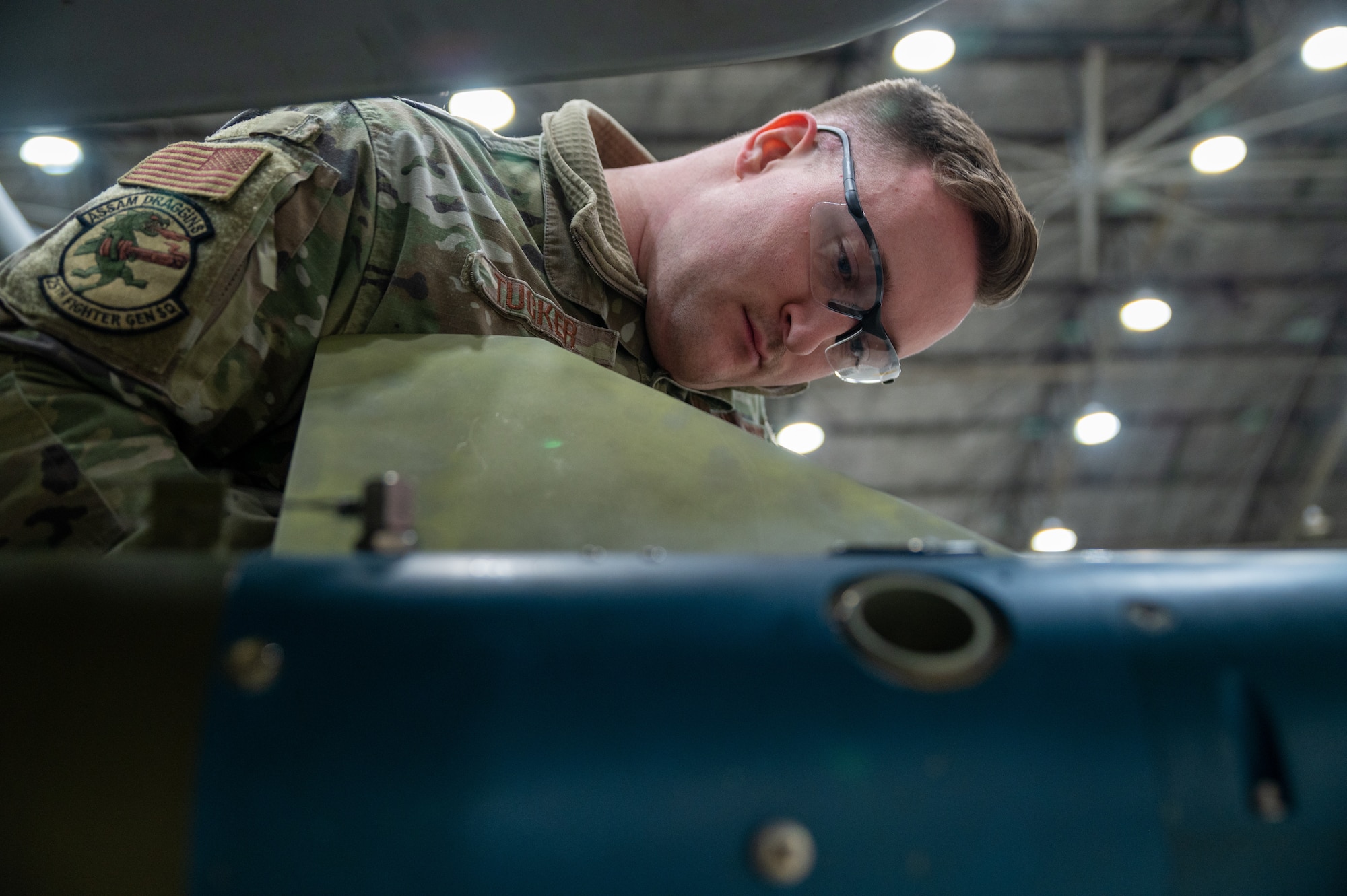 U.S. Air Force Senior Airman Alec Tucker, 25th Fighter Generation Squadron weapons load crew member, loads munitions onto an A-10C Thunderbolt II during the weapons load crew of the quarter competition at Osan Air Base, Republic of Korea, Jan. 12, 2023. As part of the competition, teams are evaluated on how quickly and efficiently they are able to inspect and load munitions onto their respective aircraft. (U.S. Air Force photo by Airman 1st Class Aaron Edwards)