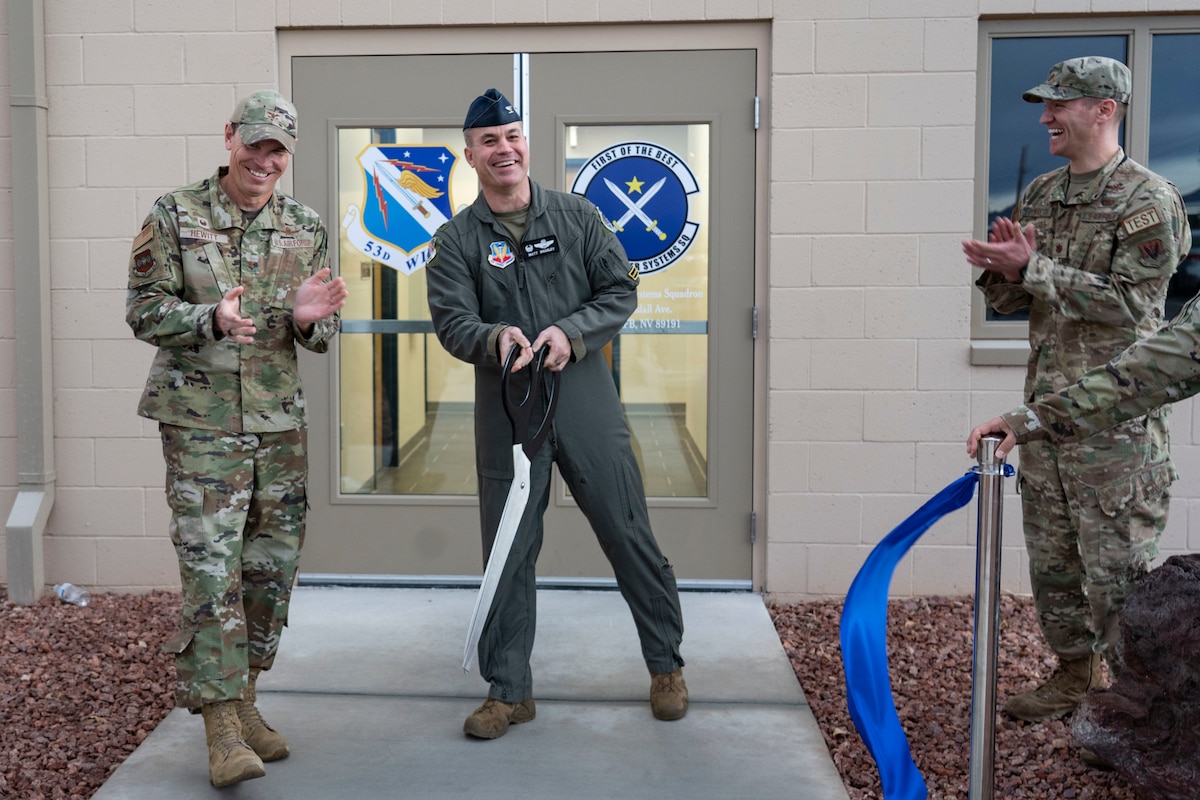 Colonel James Hewitt, 688th Cyberspace Wing commander, left, and Colonel Mathew Bradley, 53rd Wing commander, right, cheer after cutting the ribbon officially opening the 53rd Computer Systems Squadron’s new building at Nellis Air Force Base, Nevada, Jan 10. 2022. The 53rd CSS is a geographically separated unit from Eglin Air Force Base, Florida. (U.S. Air Force Photo By Airman First Class Bell)