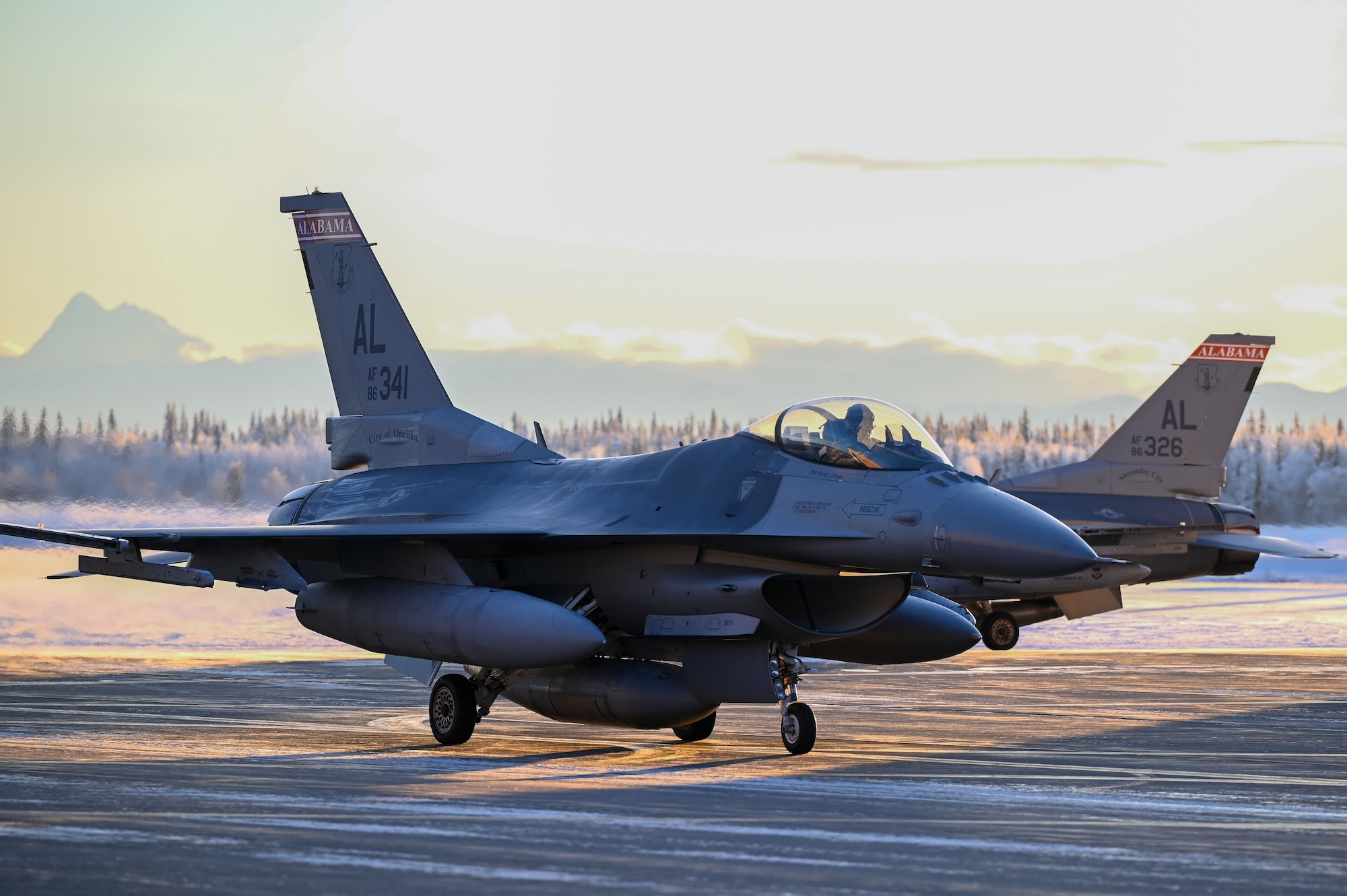 A U.S. Air Force F-16 Fighting Falcon from Dannelly Field, Air National Guard Base, taxis into a hangar at Eielson Air Force Base, Alaska, Jan. 12, 2023.