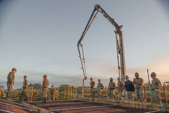 NAVAL STATION ROTA, Spain (Jan. 10, 2023) Seabees assigned to Naval Mobile Construction Battalion (NMCB) 11 prepare to place a concrete roof on a project site onboard Naval Station Rota, Spain, Jan. 10, 2023.