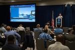 Attendees watch a cyber security demo during the third annual Global Marine Transportation (MTS) Cybersecurity Symposium in Long Beach, California, May 12, 2022. In addition to strengthening partnerships internationally, the Coast Guard recently created a cyber reserve unit that it is actively soliciting enlisted members and chief warrant officers to join. Photo by Petty Officer 3rd Class Aidan Cooney)
