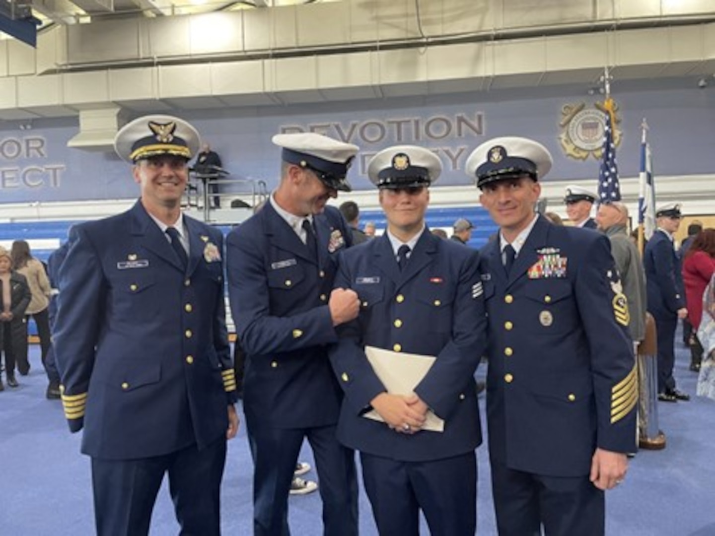 Cutline: Seaman Jackson Midgett (second from right), celebrates his boot camp graduation with Master Chief Petty Officer Aaron Turbett (second from left) Nov. 18, 2022. in Cape May, New Jersey. As a recruiting liaison Turbett found a way to help Midgett realize his dream of joining the Coast Guard.