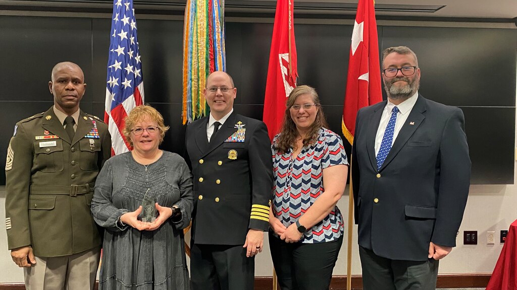 Immediately following the presentation of the USACE Peer Supporter of the Year 2022 to Lorie Polk for her role in the Critical Incident Stress Management Team, Polk is surrounded by USACE Cmd. Sgt. Maj. Patrickson Toussaint, USACE Command Surgeon Navy Captain Thomas Janisko, and TAM members Marcie Piper and Matthew Kenney.