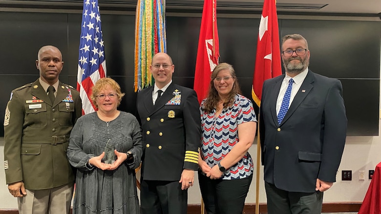 Immediately following the presentation of the USACE Peer Supporter of the Year 2022 to Lorie Polk for her role in the Critical Incident Stress Management Team, Polk is surrounded by USACE Cmd. Sgt. Maj. Patrickson Toussaint, USACE Command Surgeon Navy Captain Thomas Janisko, and TAM members Marcie Piper and Matthew Kenney.