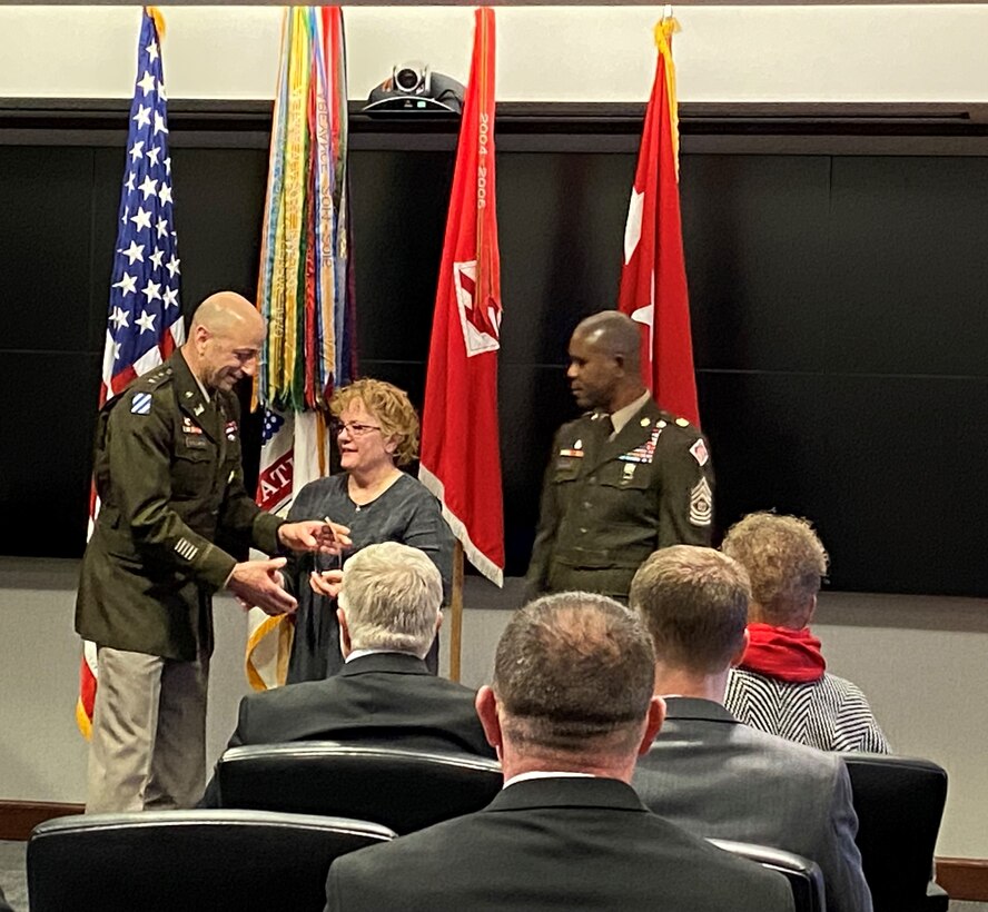55th Chief of Engineer Lt. Gen. Scott Spellmon and USACE Cmd. Sgt. Maj. Patrickson Toussaint present the 2022 USACE Peer Supporter of the Year Award to Transatlantic Middle East District's Lorie Polk, during a cermony held at HQUSACE on Jan. 11, 2023.