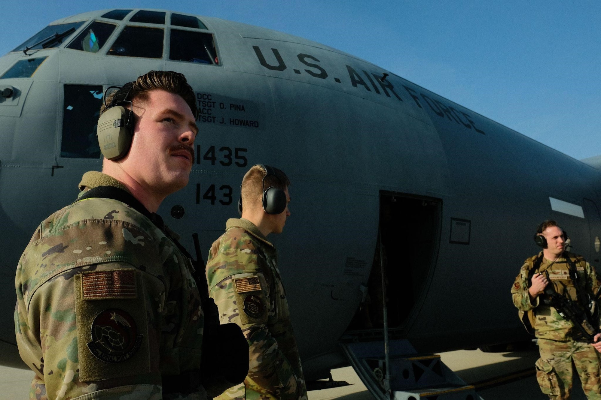 U.S. Air Force Senior Airman Colden Fuller, 305th Aerial Port Squadron fleet service technician, overlooks as service members assigned to the 621st Contingency Response Wing board a C-130 Hercules as part of exercise Jersey Devil on Joint Base McGuire-Dix-Lakehurst, N.J., Jan. 11, 2023. Jersey Devil 23, a U.S. Air Force mobility exercise hosted by the 621st CRW, tests the abilities of multi-capable airmen to rapidly deploy, establish and control airbases alongside joint allies and partners. (U.S. Air Force photo by Senior Airman Joseph Morales)